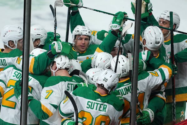 Minnesota Wild defenseman Matt Dumba (24) was mobbed by his teammates on the ice after scoring the game winning goal past Los Angeles Kings goaltender