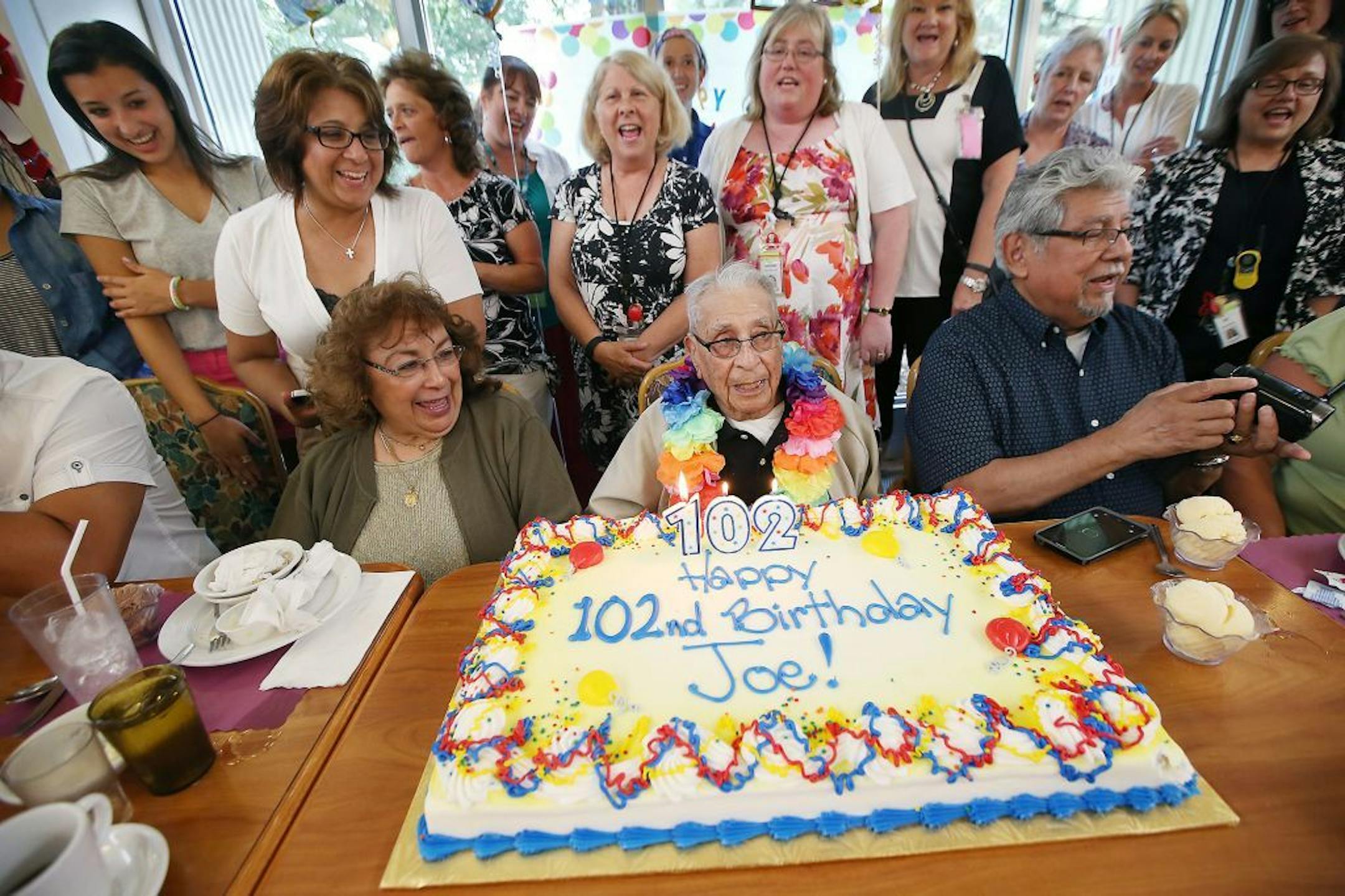 "I've been tired for the last two years," said Joe Medina, center, after staff and his family celebrated his 102nd birthday at Cerenity Senior Care, Tuesday, July 19, 2016 in St. Paul, MN.