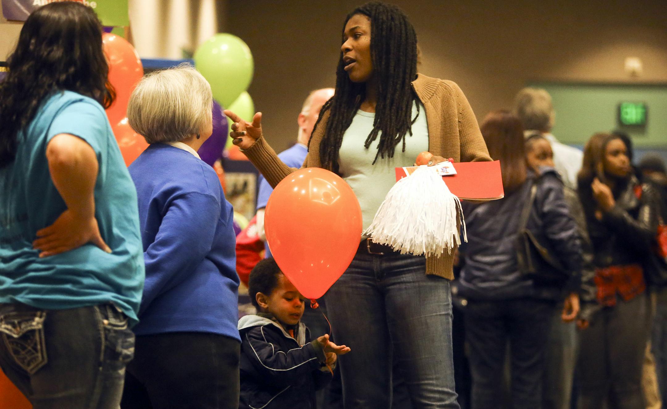 MPS mom Tracine Asberry, who is also a MInneapolis School Board member, chats while her son Miles Asberry-Wallace, 2, plays with a balloon Saturday, Jan. 25, 2014, at the School Choice fair at the Minneapolis Convention Center in Minneapolis, MN. ](DAVID JOLES/STARTRIBUNE) djoles@startribune.com For parents of U.S.-born black students, enrolling in Minnepaolis public schools is like playing the lottery. Learning to read? There's a one is five chance your child will achieve proficiency. Graduate