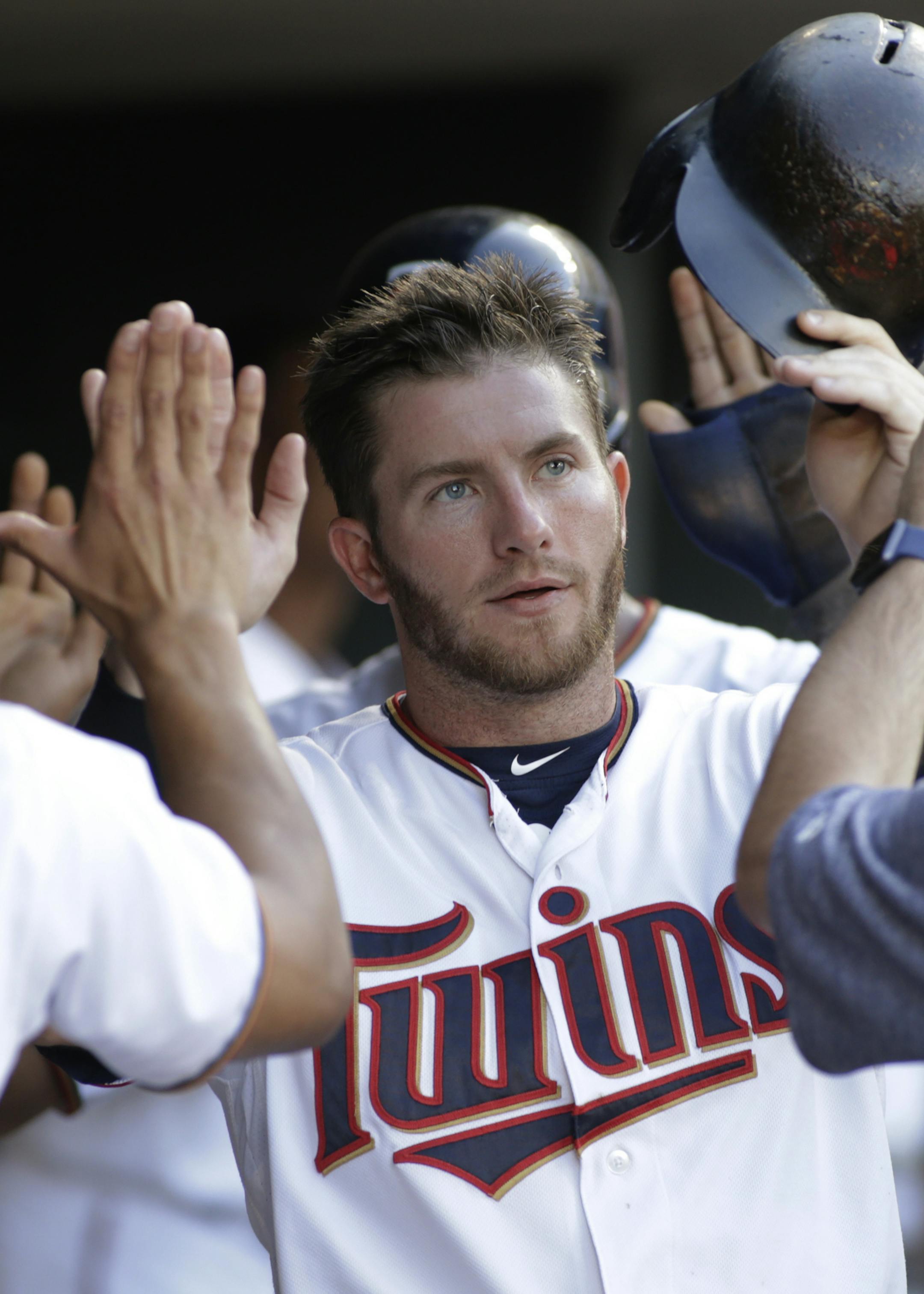 Minnesota Twins' Robbie Grossman is congratulated by teammates after he scored during the third inning of the team's baseball game against the Baltimore Orioles, Thursday, July 6, 2017, in Minneapolis. (AP Photo/Paul Battaglia)