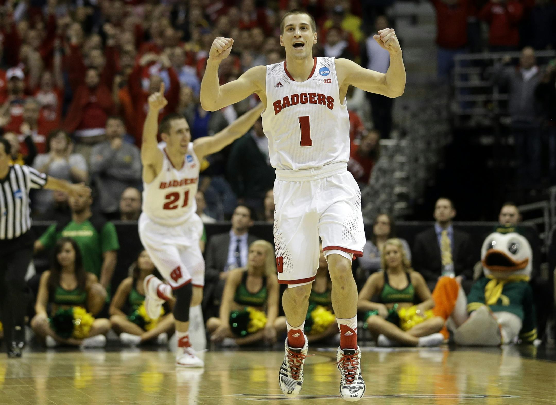 Wisconsin guards Ben Brust (1) and Josh Gasser (21) react to a foul call against Oregon during the second half of a third-round game of the NCAA college basketball tournament Saturday, March 22, 2014, in Milwaukee. Wisconsin won 82-77. (AP Photo/Morry Gash)