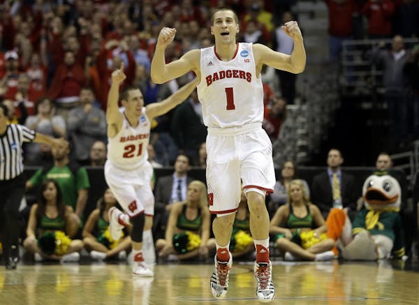 Wisconsin guards Ben Brust (1) and Josh Gasser (21) react to a foul call against Oregon during the second half of a third-round game of the NCAA colle
