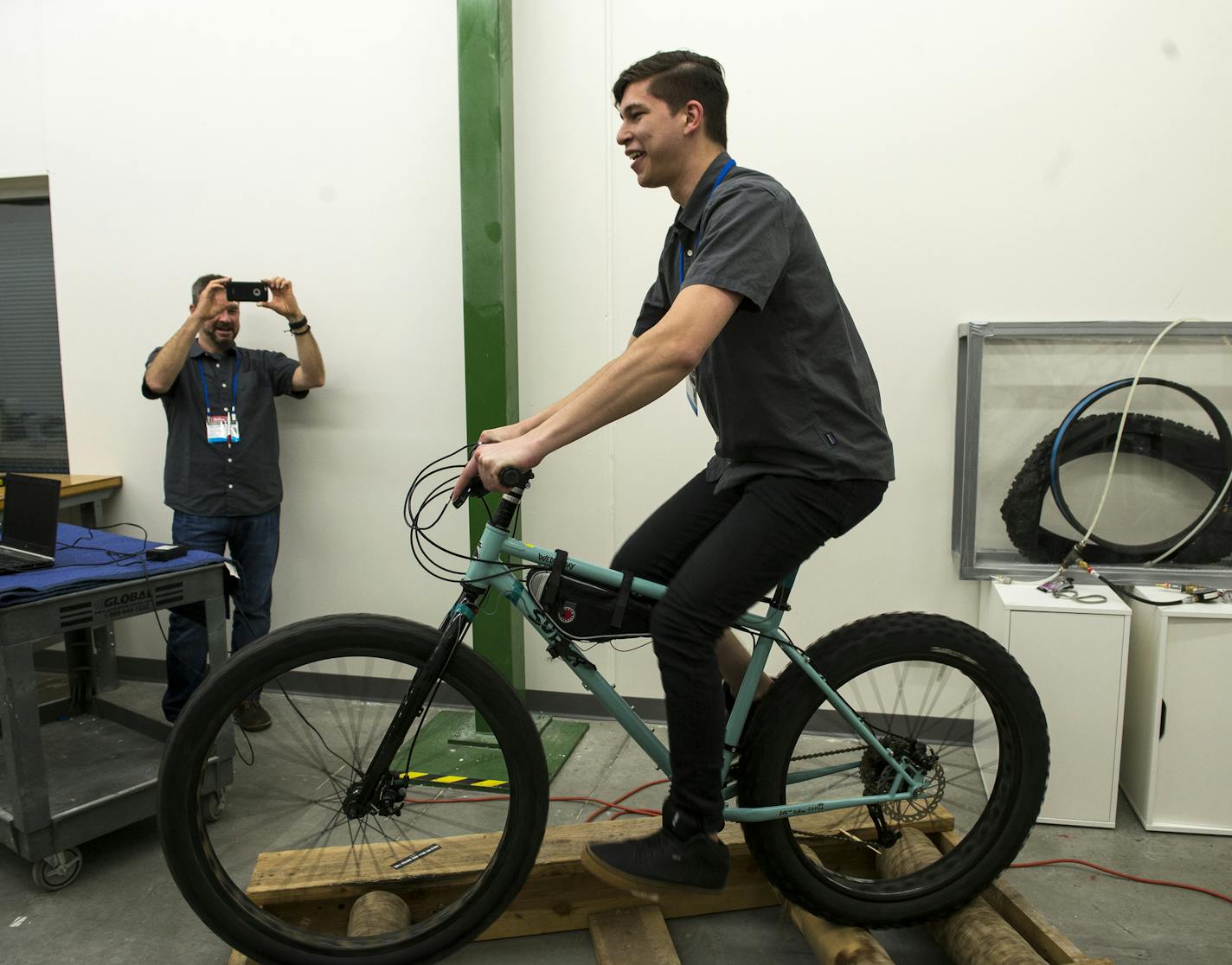 Jake Diaz, with Hayes Components, attempted riding a Surly bicycle on the log roller in Quality Bike Products' testing lab Sunday. The roller is used in conjunction with an electronic strain gauge which measure stress on the bicycles frame and relays the information to a nearby computer. ] (AARON LAVINSKY/STAR TRIBUNE) aaron.lavinsky@startribune.com Frostbike 2016 was held at the Quality Bike Products Campus on Saturday, Feb. 27, 2016 in Bloomington, Minn.