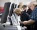 Election judges from ward 1, precinct 10, Joan Curtis and Merlin Davis, conduct a public accuracy test with a ballot tabulator on Tuesday, Nov. 1, 201