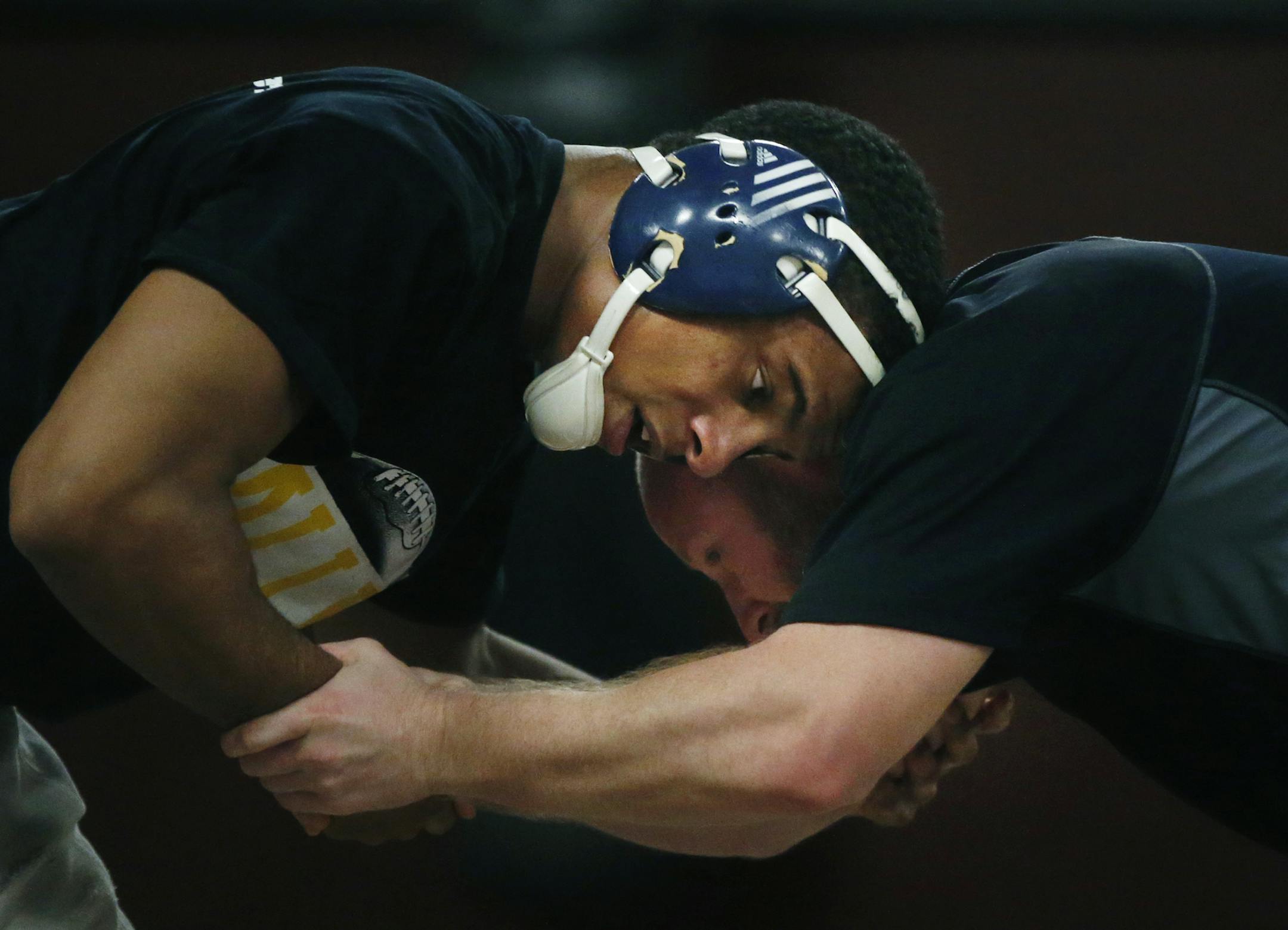 Apple Valley’s Mark Hall, here westling with assistant wrestling coach Jake Avre, is considered, pound-for-pound, the best high school wrestler in the nation and is seeking his fifth state wrestling title Saturday. The junior, who moved to Apple Valley to wrestle, is competing in the 170-pound weight class and already is being coveted by top Division I programs.
