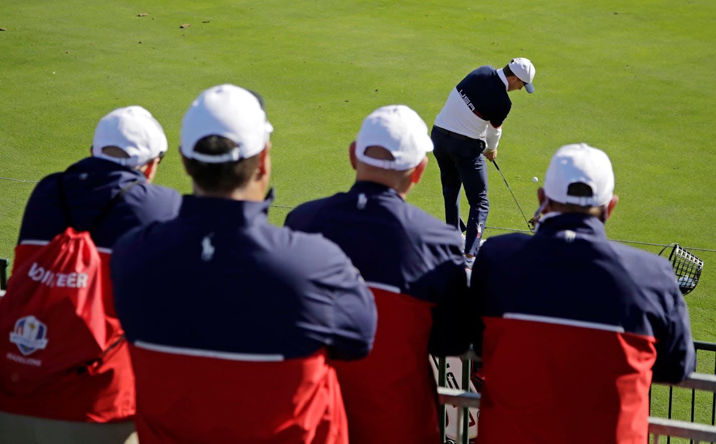 Volunteers watched as the United States' Jordan Spieth hit balls on the driving range before the Ryder Cup golf tournament Monday at Hazeltine National Golf Club in Chaska.