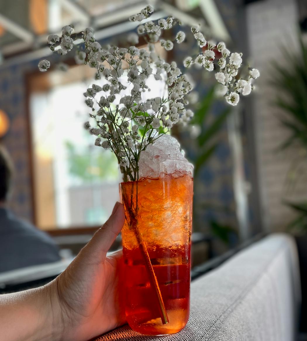 An Aperol Spritz sports a bridal bouquet’s worth of baby’s breath.