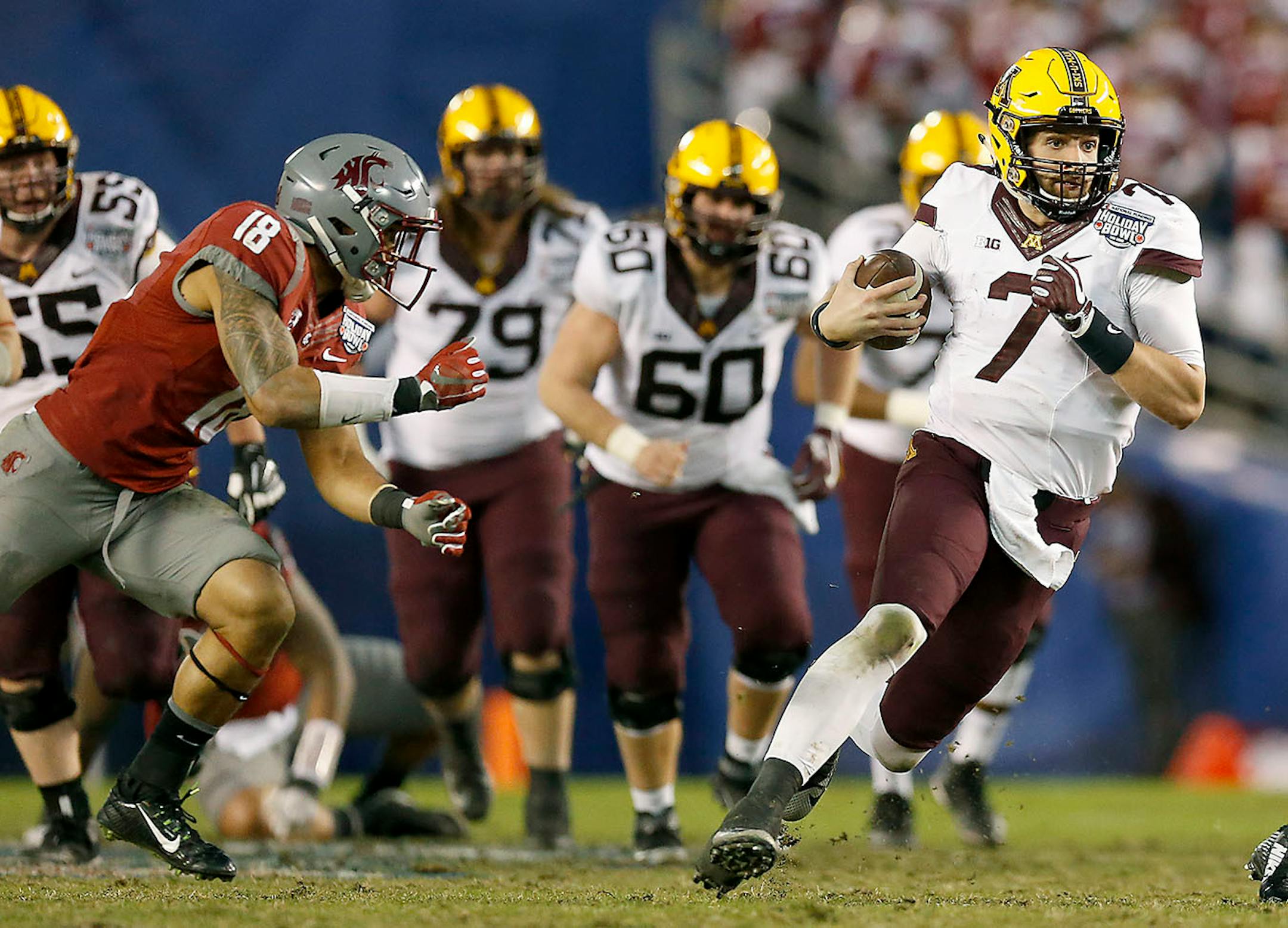 Minnesota's quarterback Mitch Leidner ran for a first down during the second quarter as they took on Washington State at Qualcomm Stadium for the San Diego Holiday Bowl, Tuesday, December 27, 2016 in San Diego, CA.