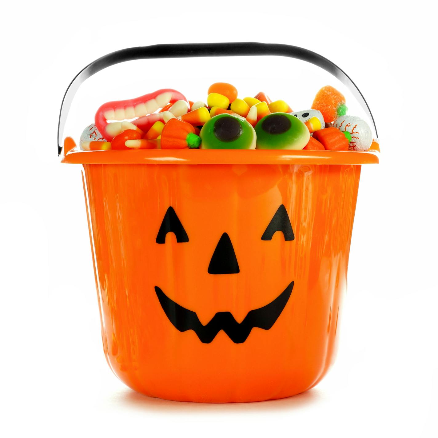 Halloween Jack o Lantern candy collector filled with candy over a white background