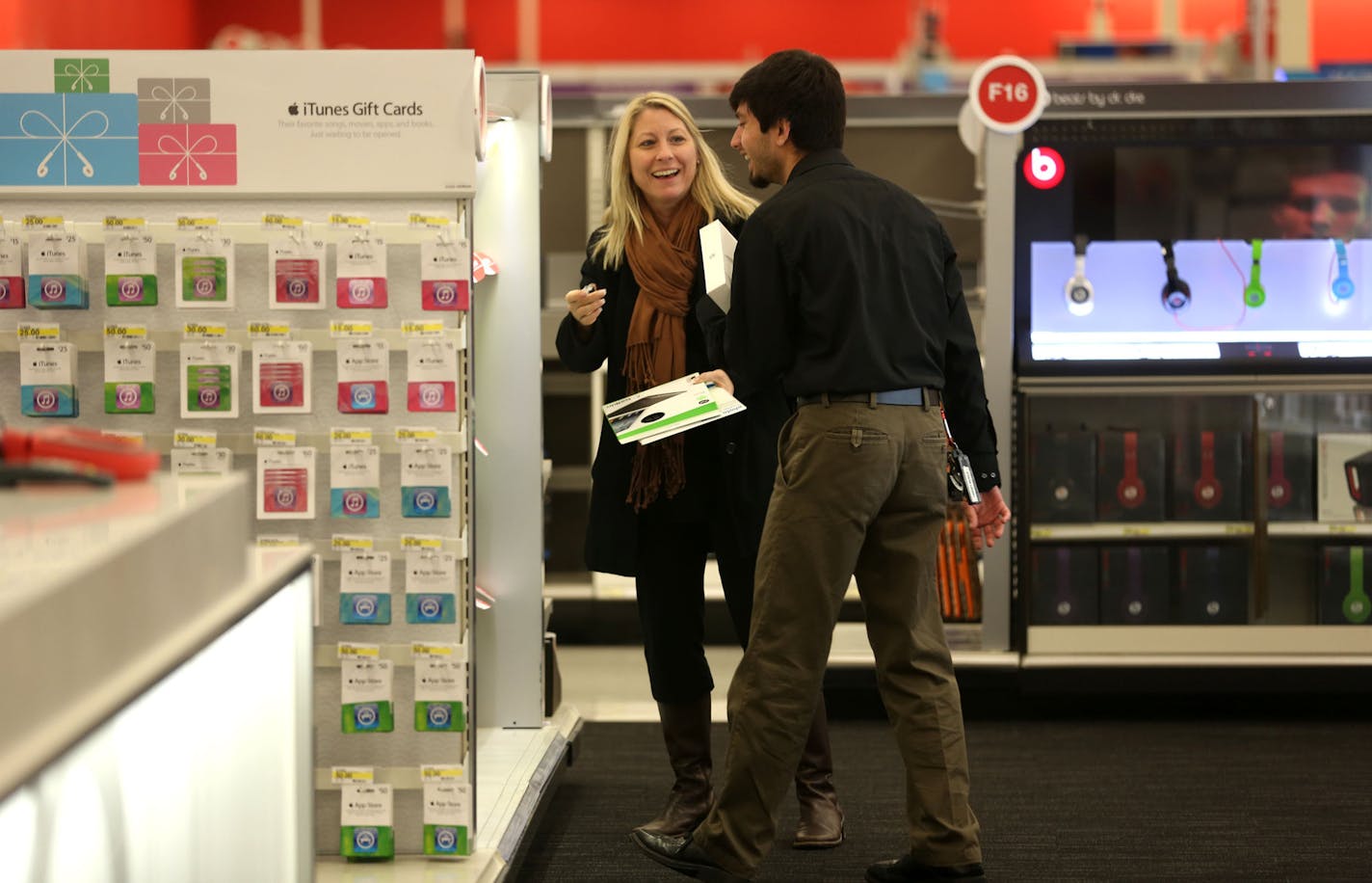 Ali Sultani, of Target, laughed with customer, Kris Hedberg, of Minneapolis, as she picked out a birthday present for her husband in the newly renovated electronics department at Target in Minneapolis, Min., Wednesday, October 16, 2013 ] (KYNDELL HARKNESS/STAR TRIBUNE) kyndell.harkness@startribune.com