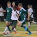 Park Center midfielder Glenn Gbakoyah maneuvers the ball around Mounds View attackers Viktor Anderson and Elijah Paulin during the first half of the C