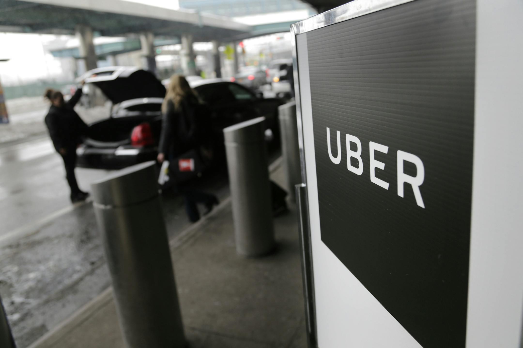 A sign marks a pick-up point for the Uber car service.