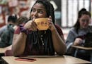 Anani Ali, holding her Paris-themed coffee cup in French class wants to attend American University in Paris to become fluent in French and become a la