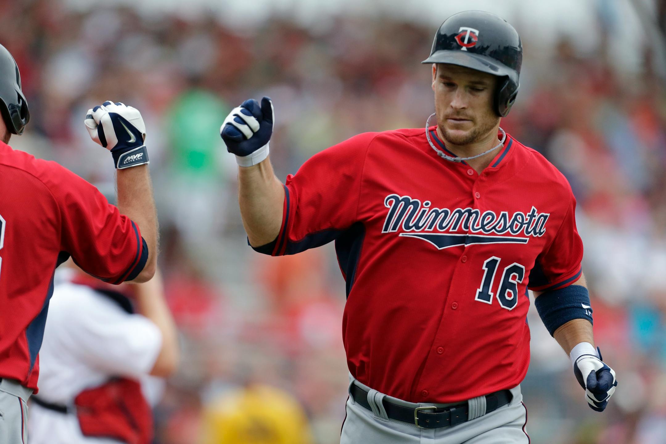 Minnesota Twins' Josh Willingham (16) is greeted by Jason Kubel after hitting a solo home run during the second inning of an exhibition baseball game against the Boston Red Sox in Fort Myers, Fla., Saturday, March 29, 2014. (AP Photo/Gerald Herbert)