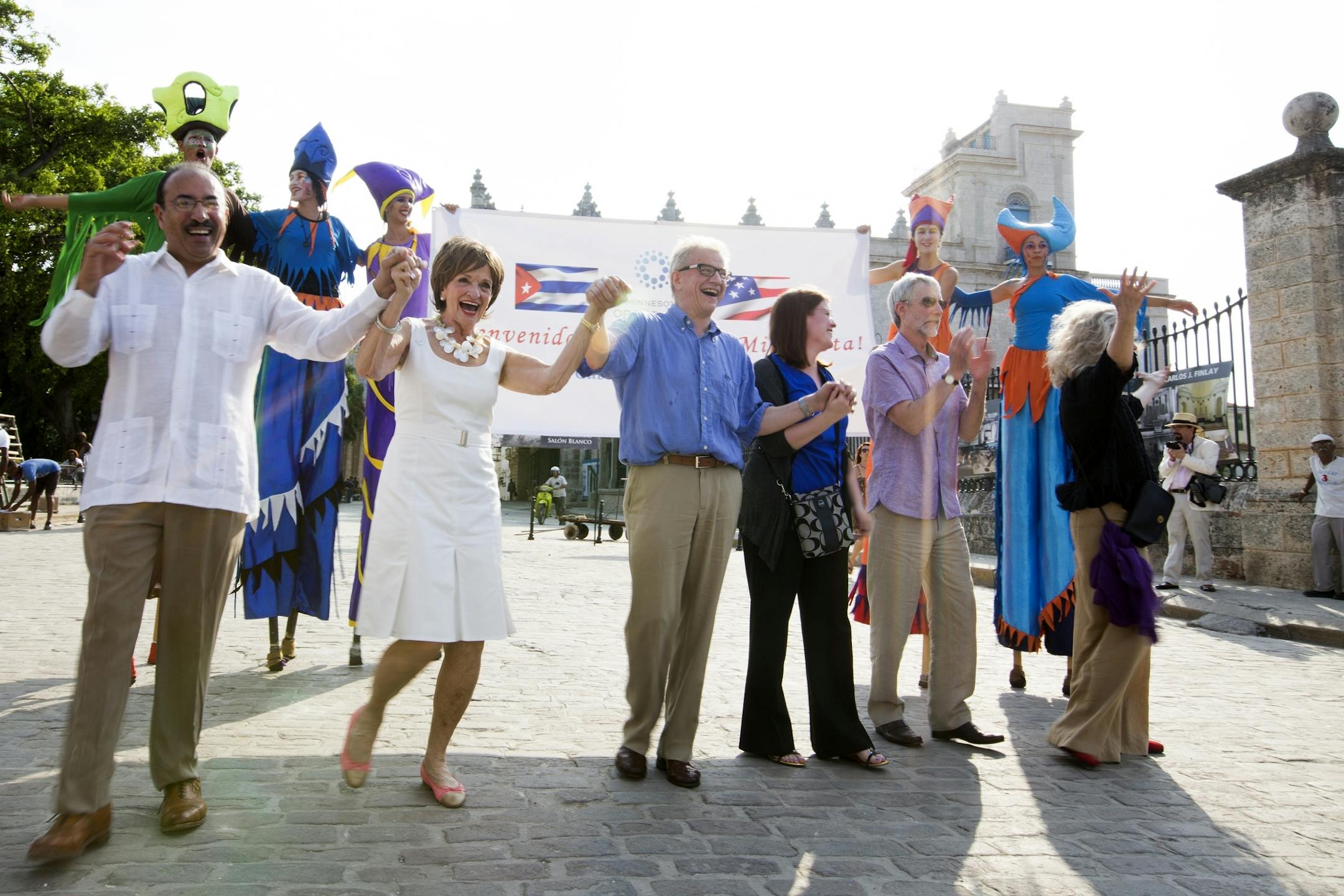 Members and supporters of the Minnesota Orchestra dance in front of a welcome group of stilt dancers and musicians there to greet the Minnesota Orchestra in Plaza de Armas in Old Havana, Cuba on Wednesday, May 13, 2015.