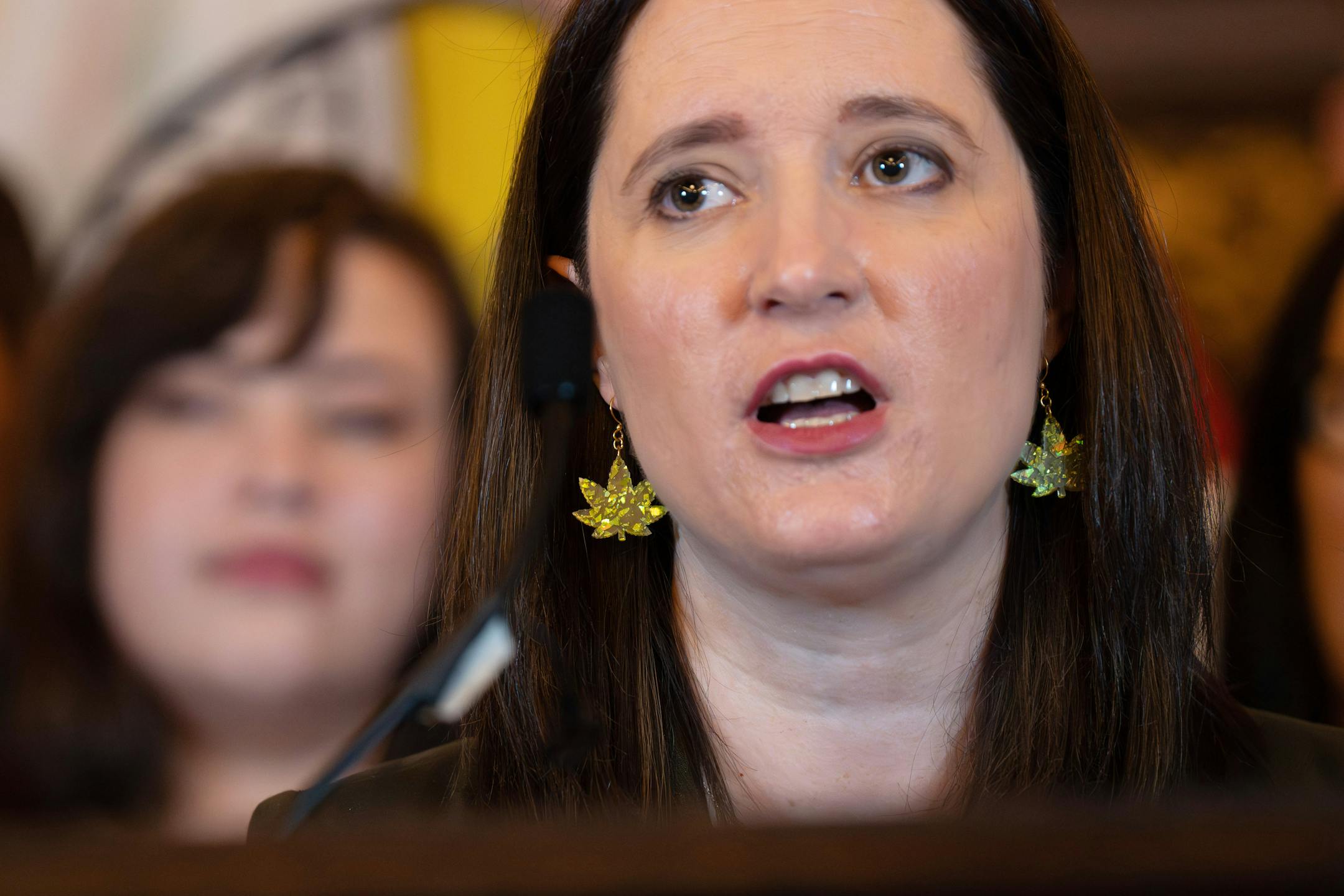 Sen. Lindsey Port, DFL-Burnsville, Senate author of the bill work marijuana leaf earrings at the bill signing as Gov. Tim Walz legalized marijuana in Minnesota with the stroke of a pen on Tuesday, May 30, 2023 St. Paul, Minn.