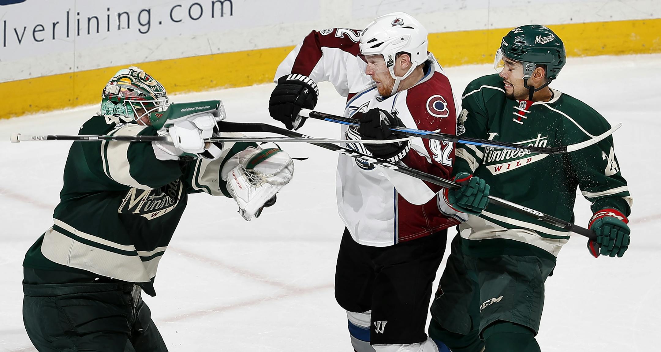 Wild goalie Devan Dubnyk (40) and Matt Dumba (24) battled with Gabriel Landeskog (92) in front of the net in the second period.