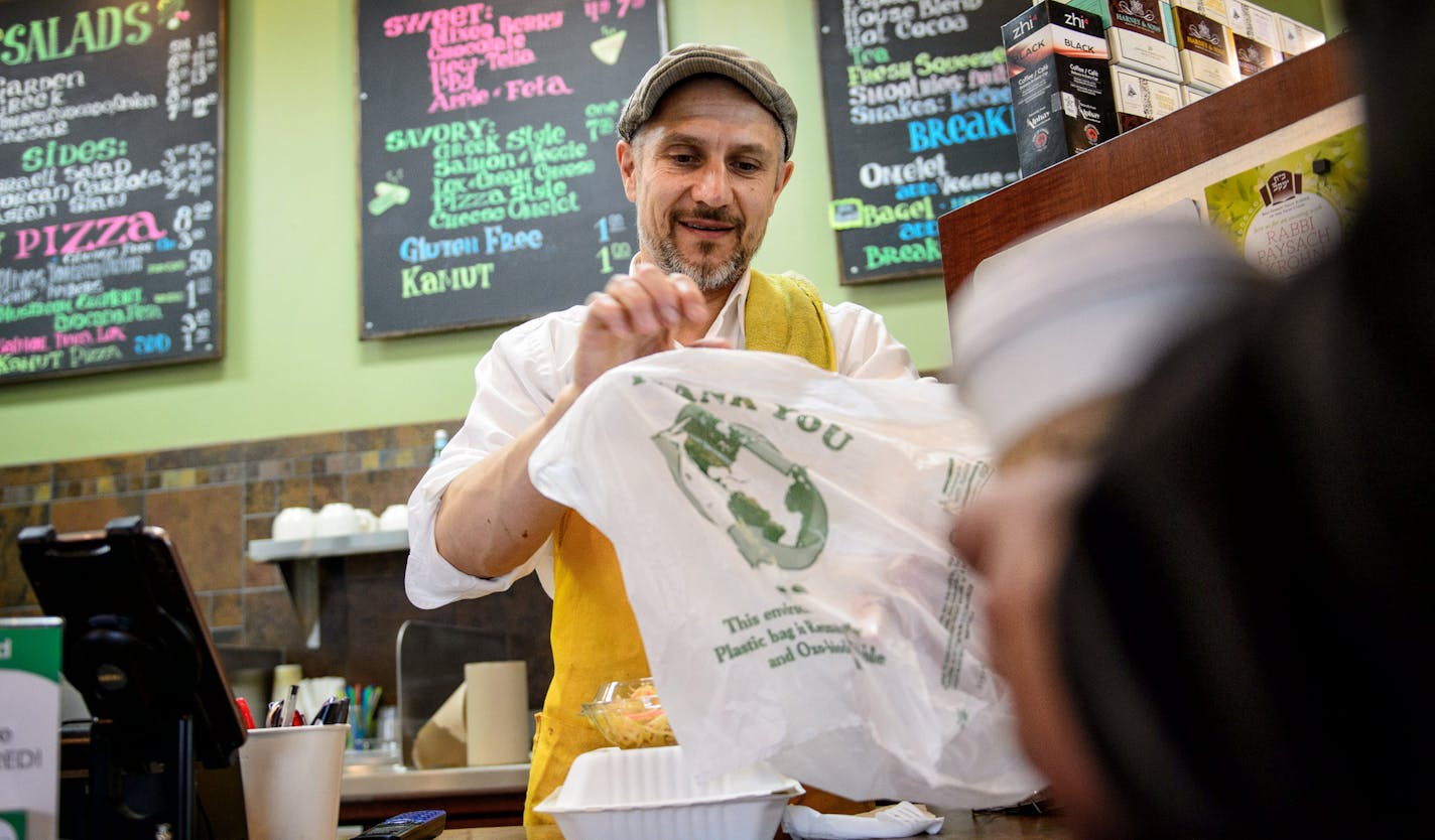 Vitaly Koval handed a carry-out food order to a customer at Vitali's Bistro in St. Louis Park. Owner Vitaly Koval uses only environmentally friendly biodegradable bags in the restaurant. ] GLEN STUBBE * gstubbe@startribune.com Monday, May 11, 2015 The handful of American cities that have banned plastic bags are the ones you'd expect, like Boulder, Colo., and Portland, Ore. But the Minnesota city that's looking at joining them might be a surprise: St. Louis Park. Over the summer, St. Louis Park p