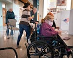 Raven Moe, 26, who has spina bifada, a spinal condition that has left her paralyzed from the waist down and in a wheelchair, fills out a ballot at the