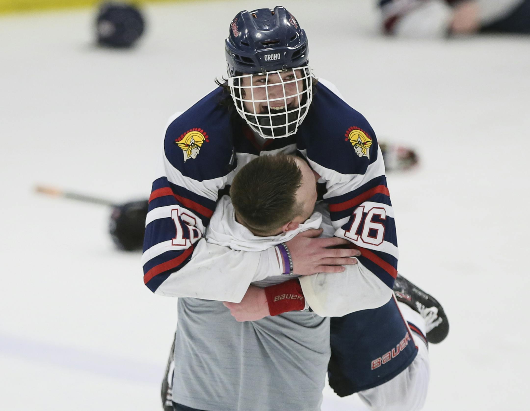 Orono forward Jack Suchy (16) celebrated with coach Will Scholz after their overtime win against Breck School in the 2A section championship in Minneapolis on Thursday, March 1, 2018. ] RENEE JONES SCHNEIDER • renee.jones@startribune.com
