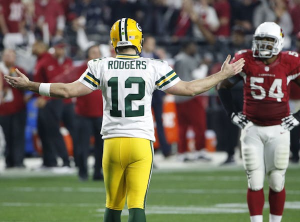 Green Bay Packers quarterback Aaron Rodgers (12) looks for a pass interference call against the Arizona Cardinals during the second half of an NFL div