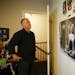 Don Amorosi paused to look at poster of Muhammad Ali, boxing gloves and photos of other athletes including Tom Brady that hang inside his son Archer's