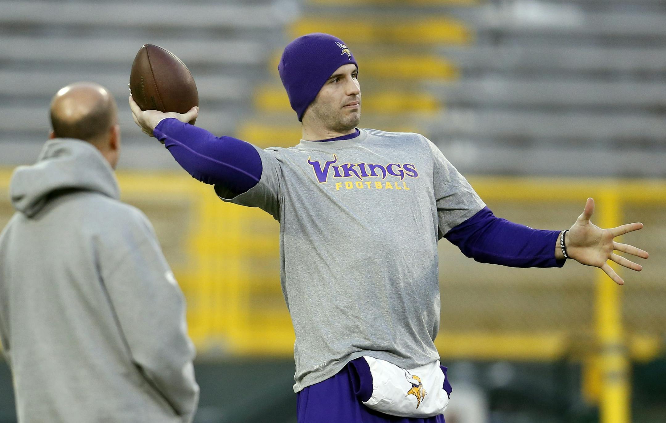 Vikings quarterback Christian Ponder threw some passes as he was watched by trainer Eric Sugarman during early pregame warm ups at Lambeau Field.