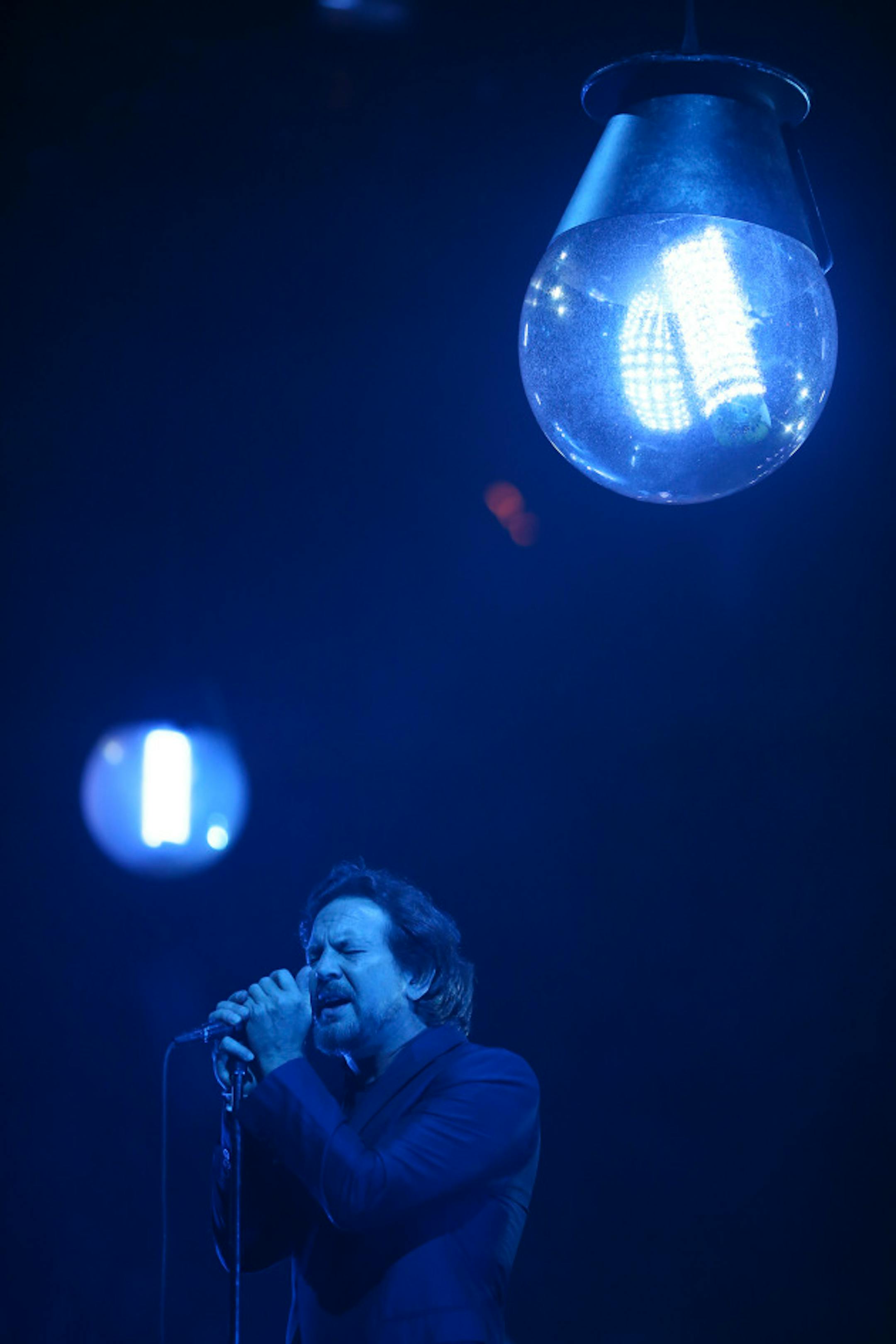 A low-lit Eddie Vedder near the start of Sunday's Pearl Jam concert at Xcel Energy Center. / Jeff Wheeler, Star Tribune