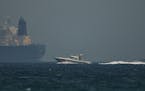 An Emirati coast guard vessel passes an oil tanker off the coast of Fujairah, United Arab Emirates, Monday, May 13, 2019. Saudi Arabia said Monday two