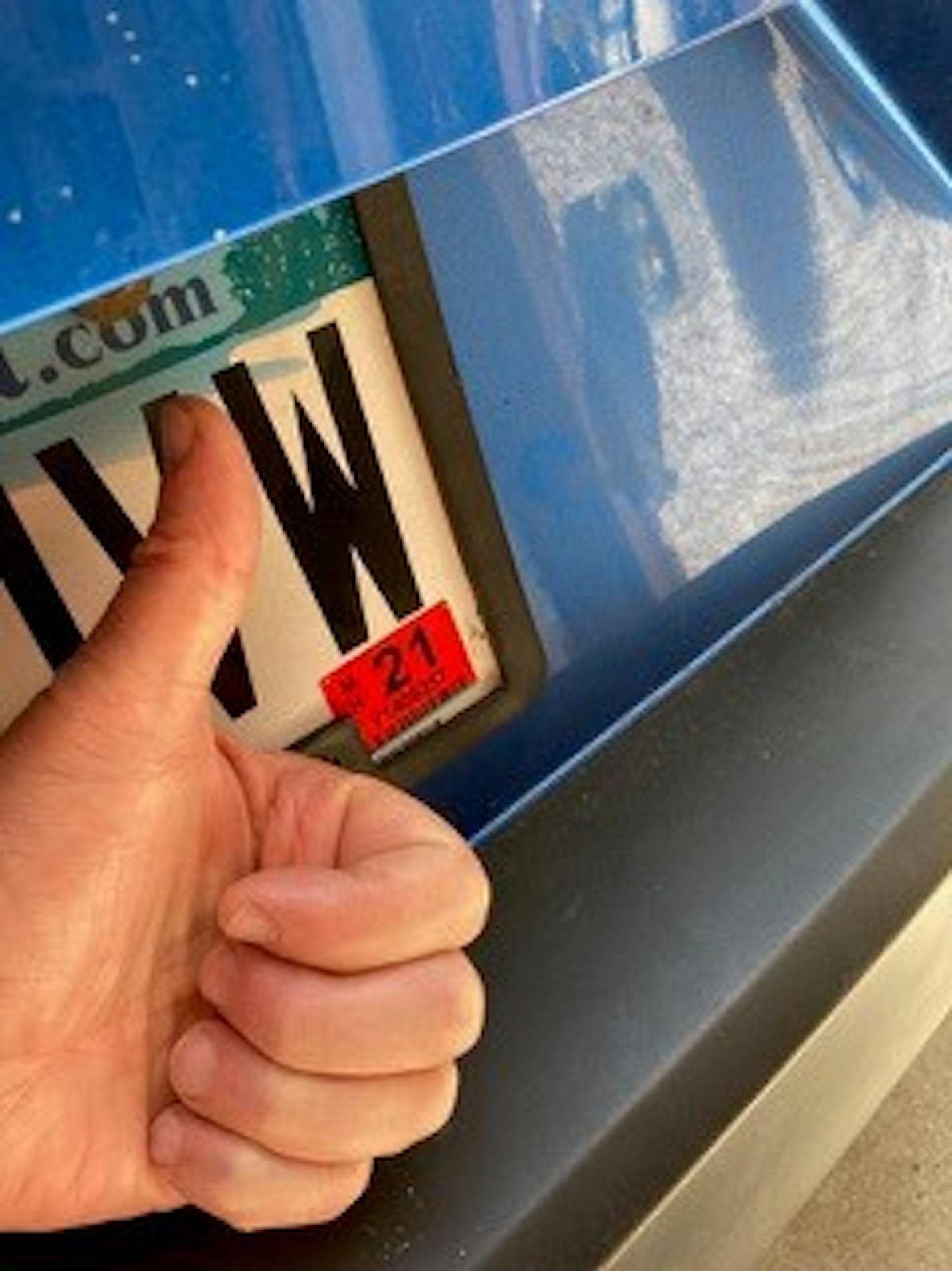 Bruce Bruemmer gave a thumbs up after waiting several weeks to get his license tabs that he renewed by mail. They came 10 days after 2020 sticker had expired.