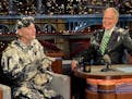 In this photo provided by CBS, actor Bill Murray, left, talks with host David Letterman after emerging from a cake to say good-bye, Tuesday, May 19, 2