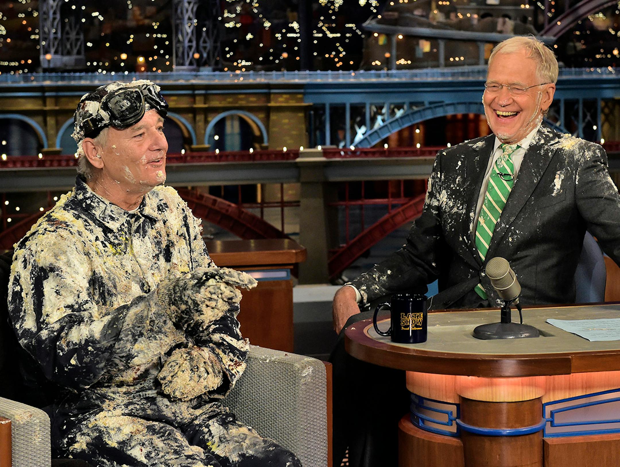 In this photo provided by CBS, actor Bill Murray, left, talks with host David Letterman after emerging from a cake to say good-bye, Tuesday, May 19, 2015, on the set of the �Late Show with David Letterman,� in New York. Letterman�s final show airs Wednesday, May 20. (John Paul Filo/CBS via AP)