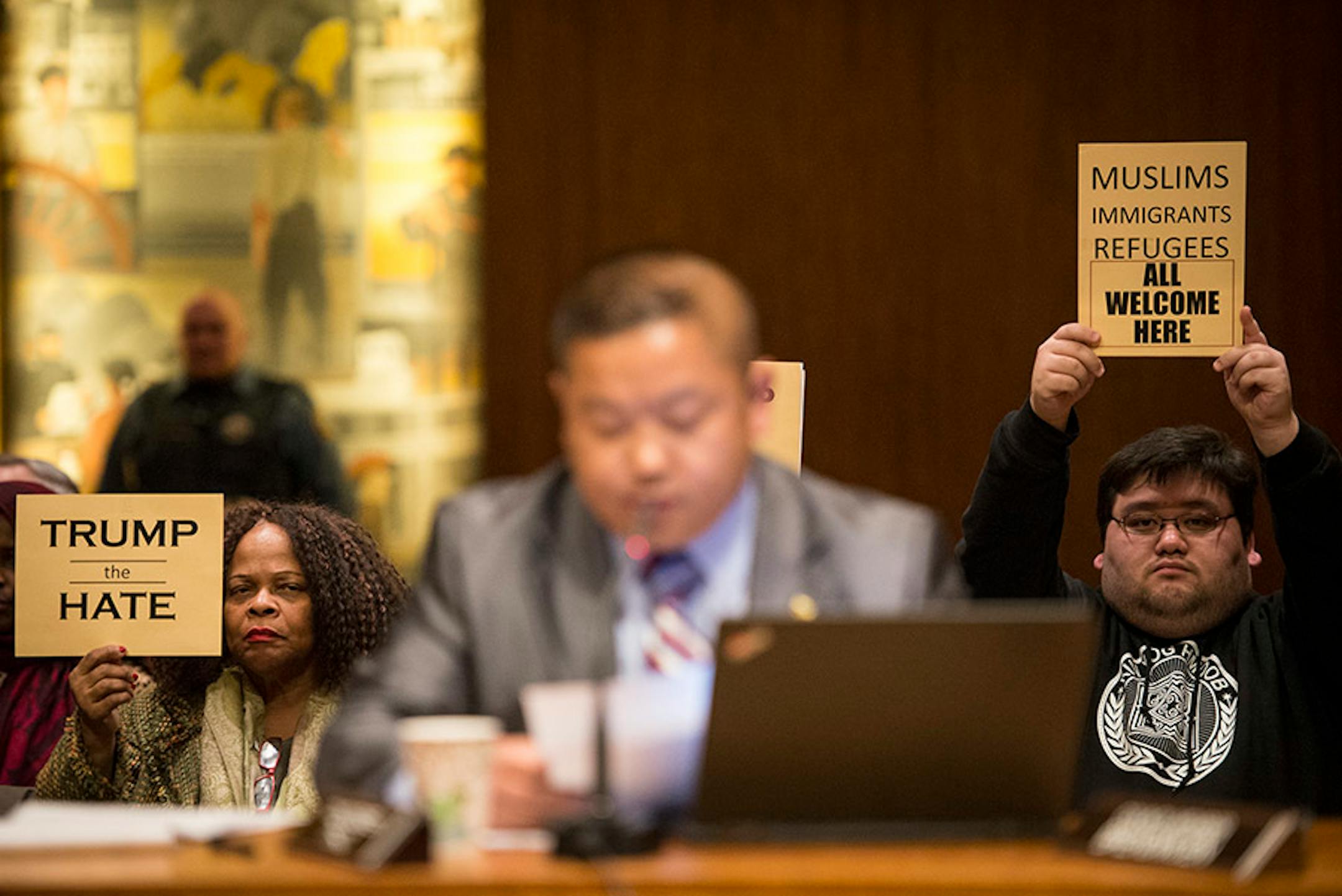 Demonstrators held anti-Trump signs at Wednesday's St. Paul City Council meeting. The St. Paul City Council voted on a resolution condemning Republican presidential candidate Donald Trump for anti-Muslim, anti-refugee and anti-immigrant speech during a meeting Wednesday night in the St. Paul City Council Chambers on Dec. 16, 2015.