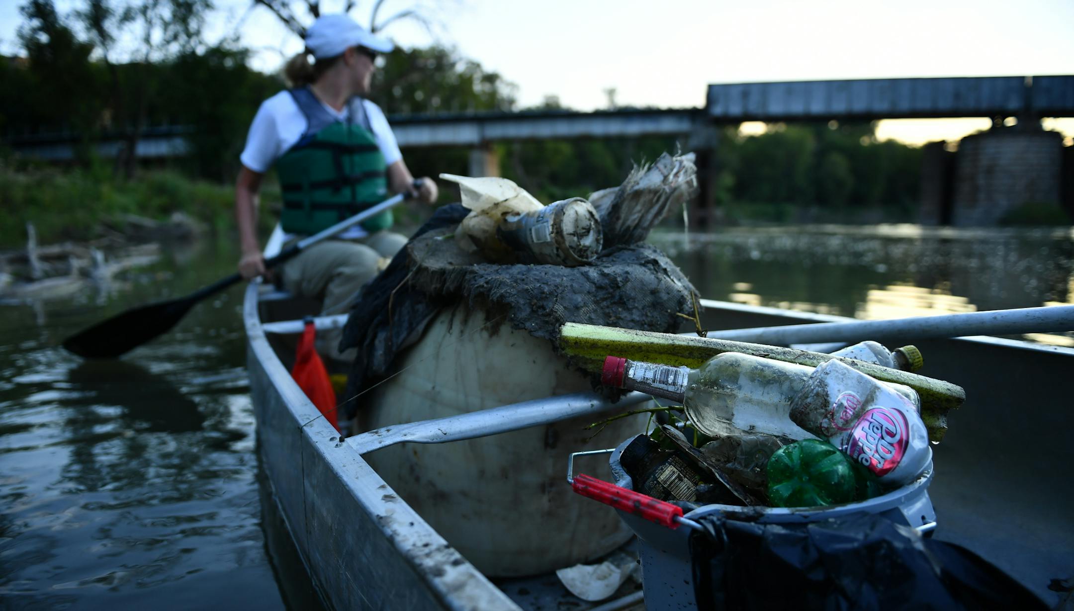 Trash, including bottles, cans and discarded clothes, filled the canoe of Christine Holland, project coordinator with the River Keepers, during a community cleanup of the Red River in late August.