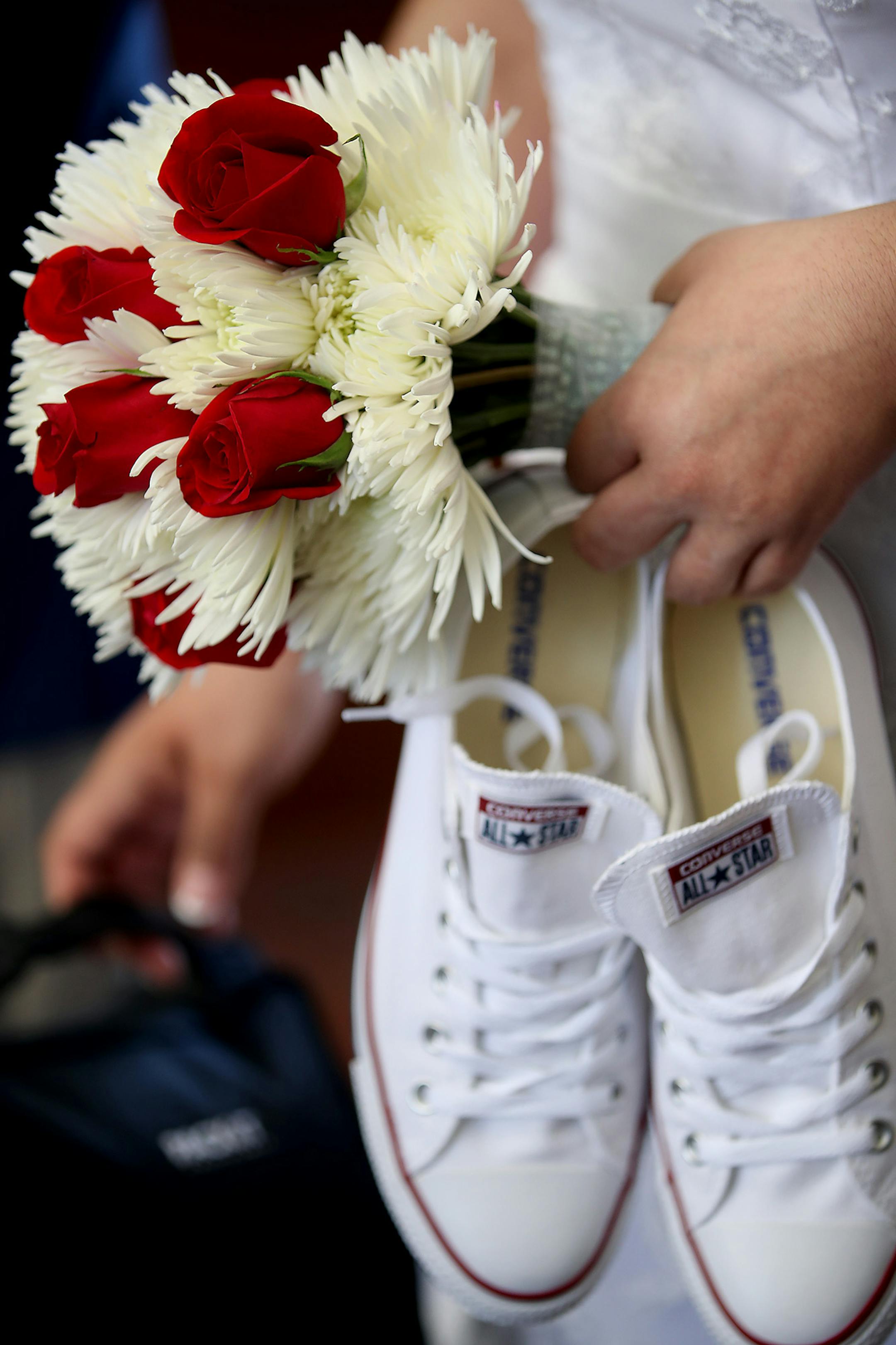 Luz V. Vargas held her tennis shoes after putting on her heels during the annual free wedding ceremony event at the Hennepin County Government Center, Tuesday, February 14, 2017 in Minneapolis, MN. ] ELIZABETH FLORES &#xef; liz.flores@startribune.com