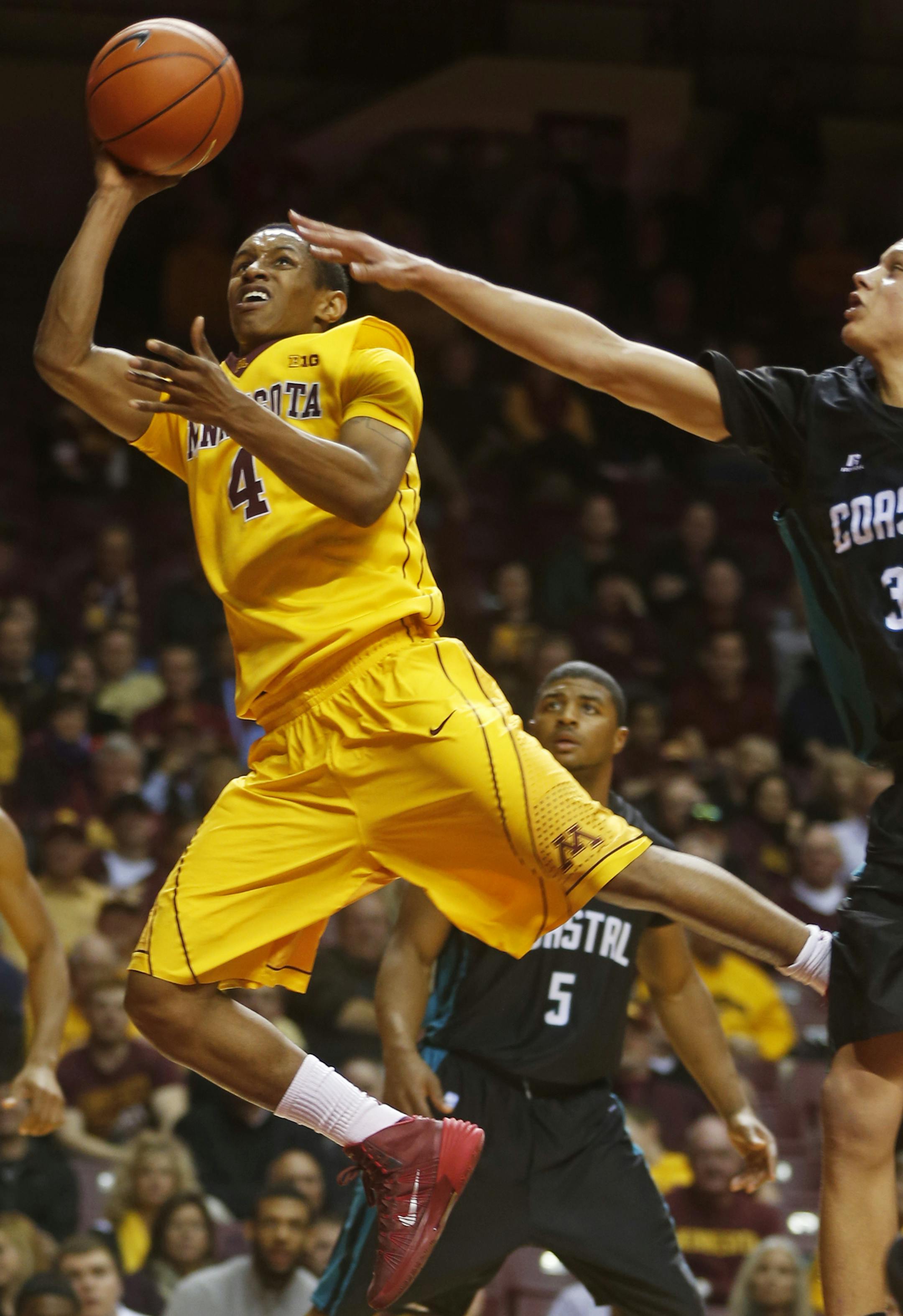 At Williams Arena in a game between the Gophers mens basketball team and Coastal Carolina, DeAndre Mathiew(4) puts up a shot as Colton Ray-St. Cyr(30) defends.]richard tsong-taatarii/rtsong-taataarii@startribune.com