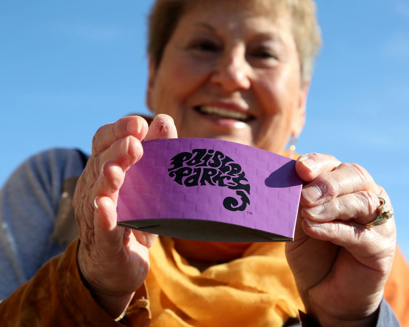 Phyllis Jackson of Red Wing didn't buy any coffee during the Paisley Park tour but she did pick up a coffee sleeve for free and showed it off at Southwest Transit Center where tour guests were picked up and dropped off for the tour Thursday, Oct. 6, 2016, in Chanhassen, MN. ](DAVID JOLES/STARTRIBUNE)djoles@startribune.com new Paisley Park Tour**Phyllis Jackson, cq