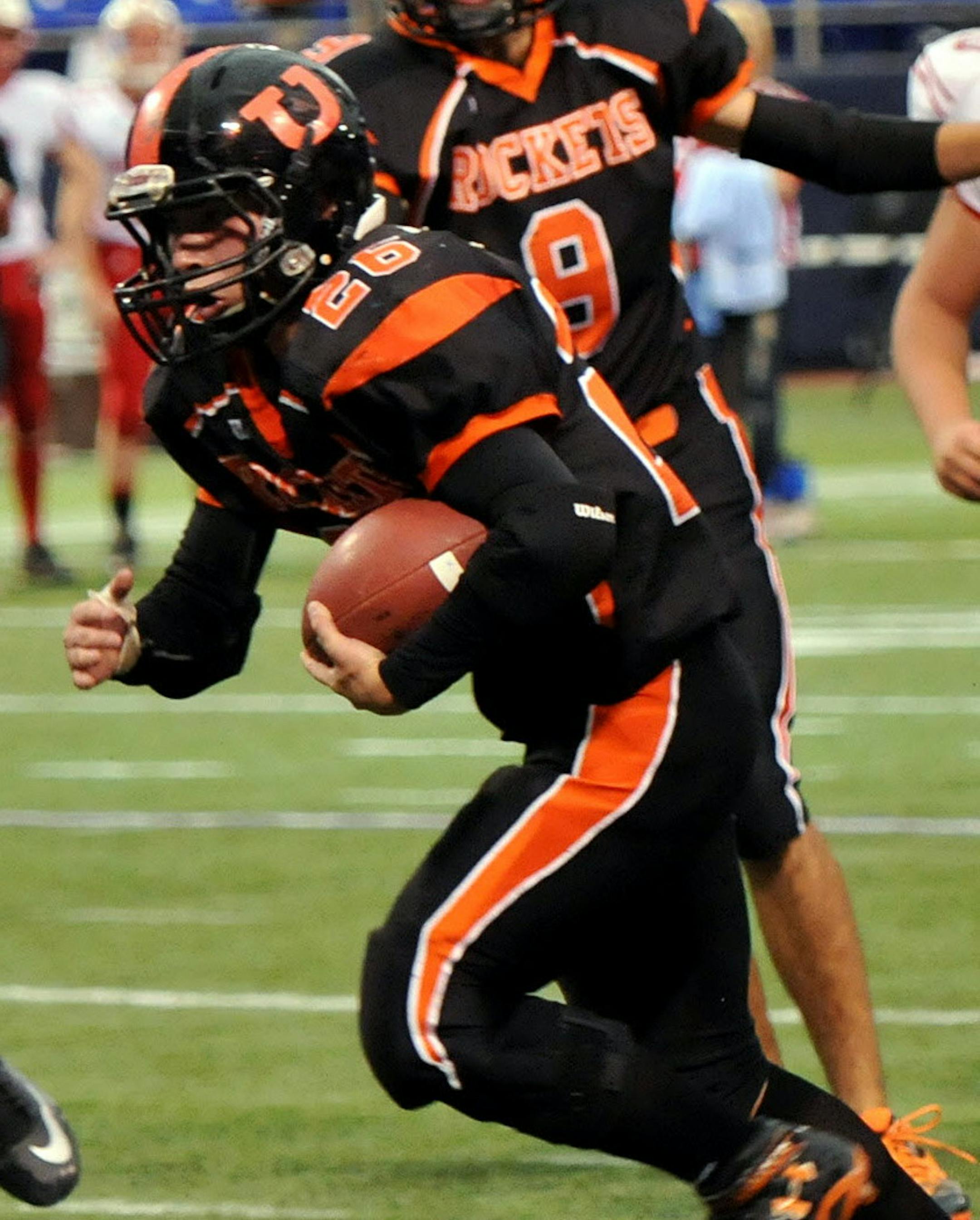 Underwood's Noah Thompson runs the ball towards the end zone during the first half of a Class 9-man semifinal Thursday at the Metrodome. Underwood led Ely 21-7 at halftime. ] (SPECIAL TO THE STAR TRIBUNE/BRE McGEE) **Noah Thompson (black, 26) ORG XMIT: MIN1311141326381090