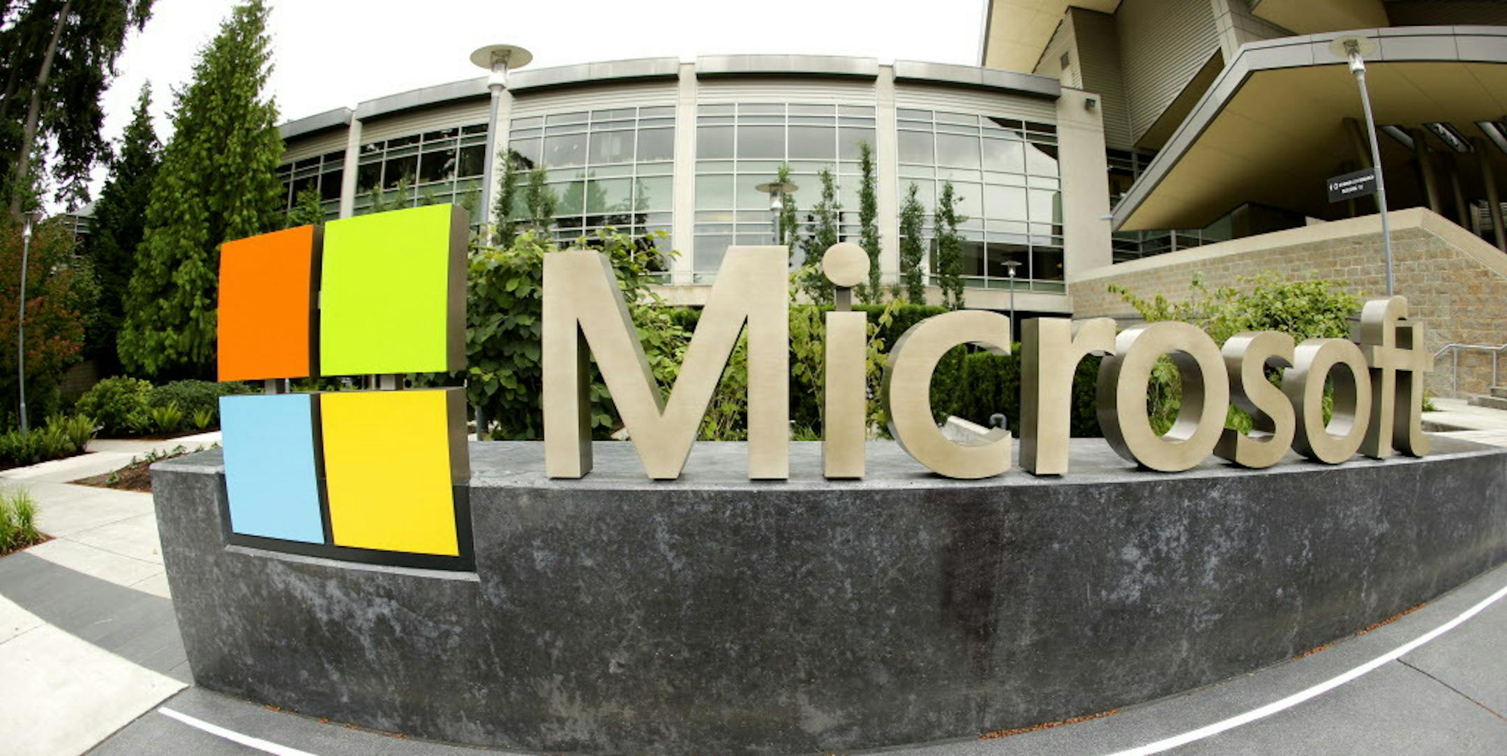 CORRECTS TO SAY THAT MICROSOFT WILL ELIMINATE UP TO 18,000 INSTEAD OF 18,000 - This photo taken with a fisheye lens on July 3, 2014 shows Microsoft Corp. signage outside the Microsoft Visitor Center in Redmond, Wash. Microsoft on Thursday, July 17, 2014 announced it will lay off up to 18,000 workers over the next year. (AP Photo Ted S. Warren)