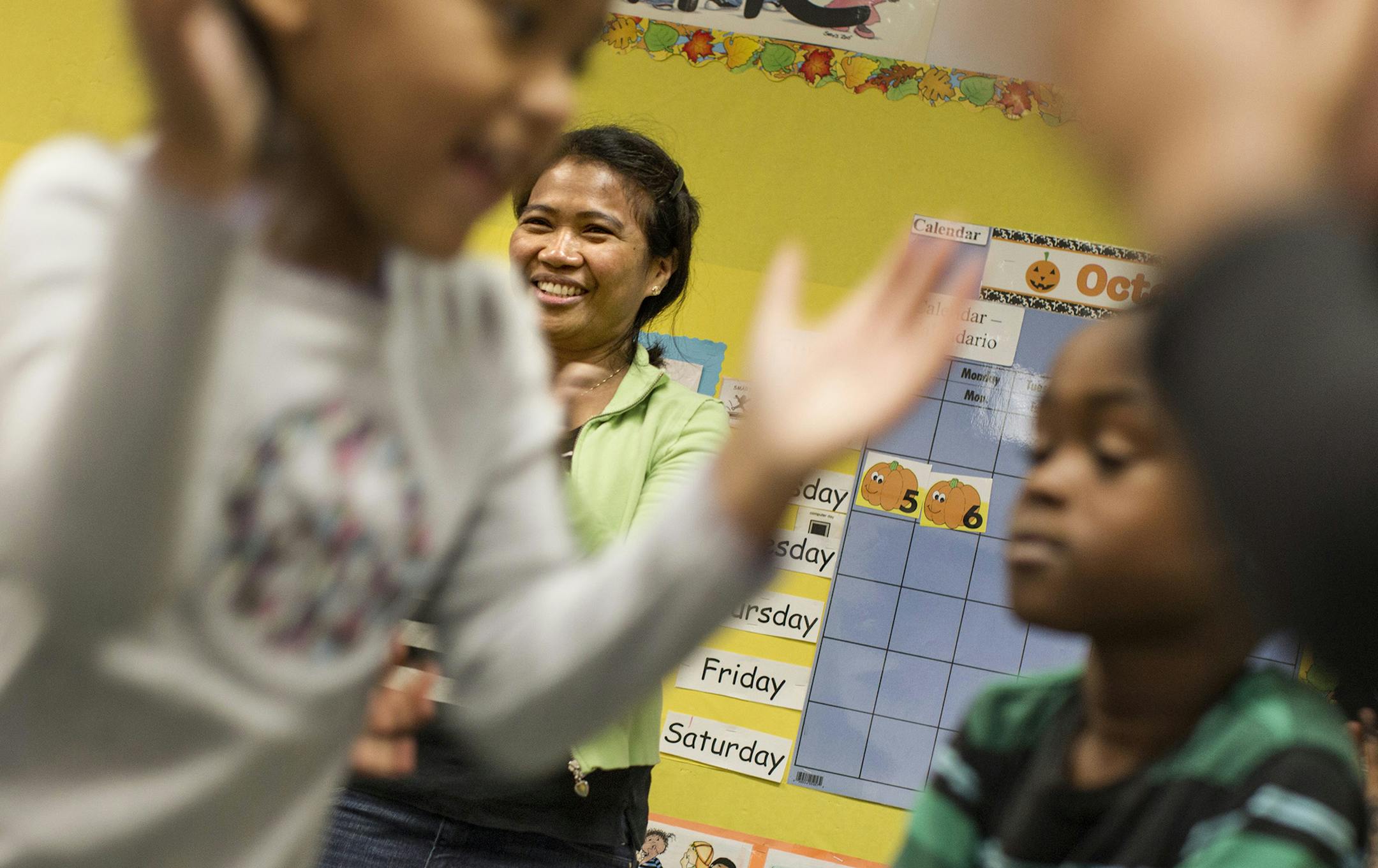 Head teacher Alfreda Schaeffer leads preschool students in movement during a learning activity at the Head Start Family Development Center in Coon Rapids October 6, 2014. The class is a comprehensive full day, full year preschool program. (Courtney Perry/Special to the Star Tribune)