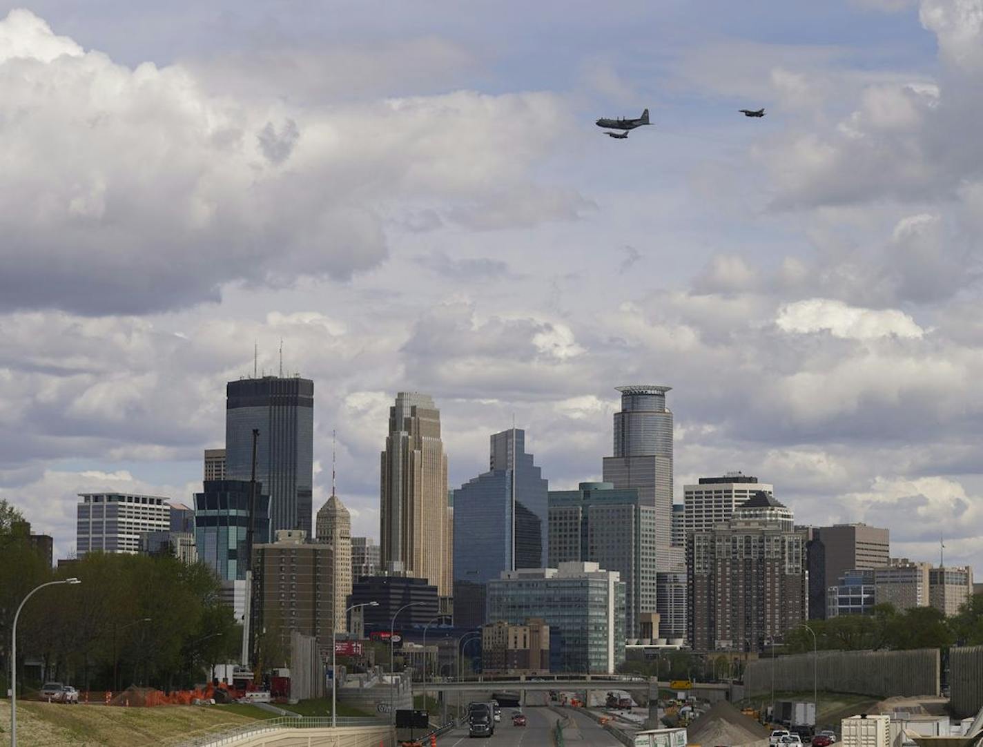 A pair of F-16 jets flanked a C-130 Hercules airplane as it flew over downtown late Wednesday morning to honor frontline health care workers.