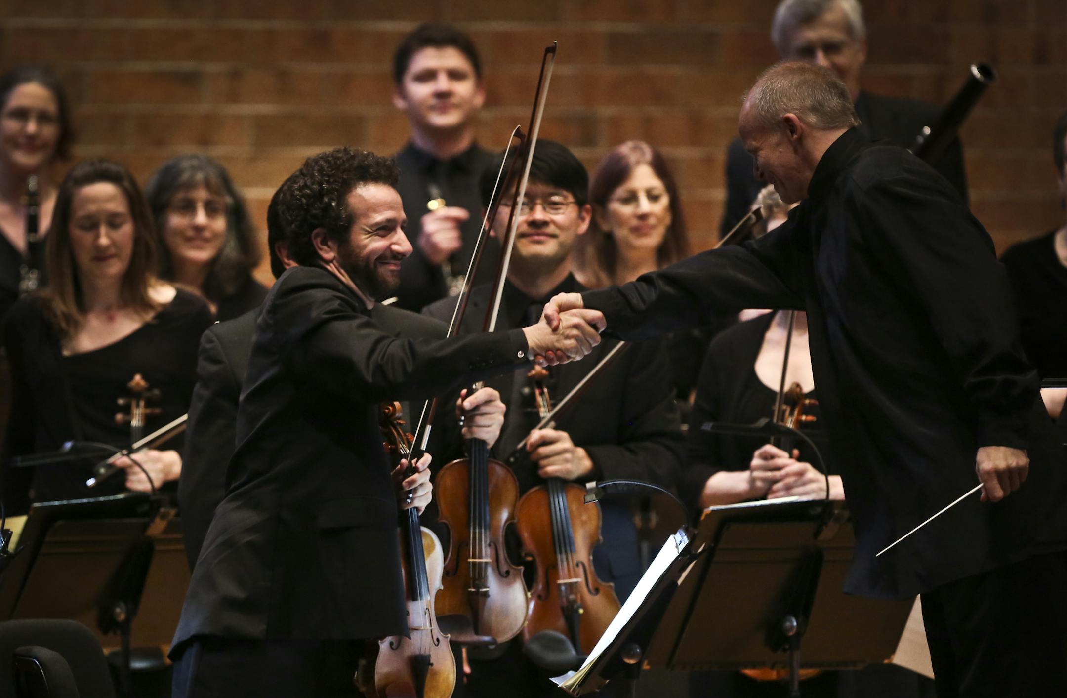 Conductor Thomas Zehetmair, right, shook hands with concertmaster Steven Copes after the St. Paul Chamber Orchestra’s first piece Thursday night.