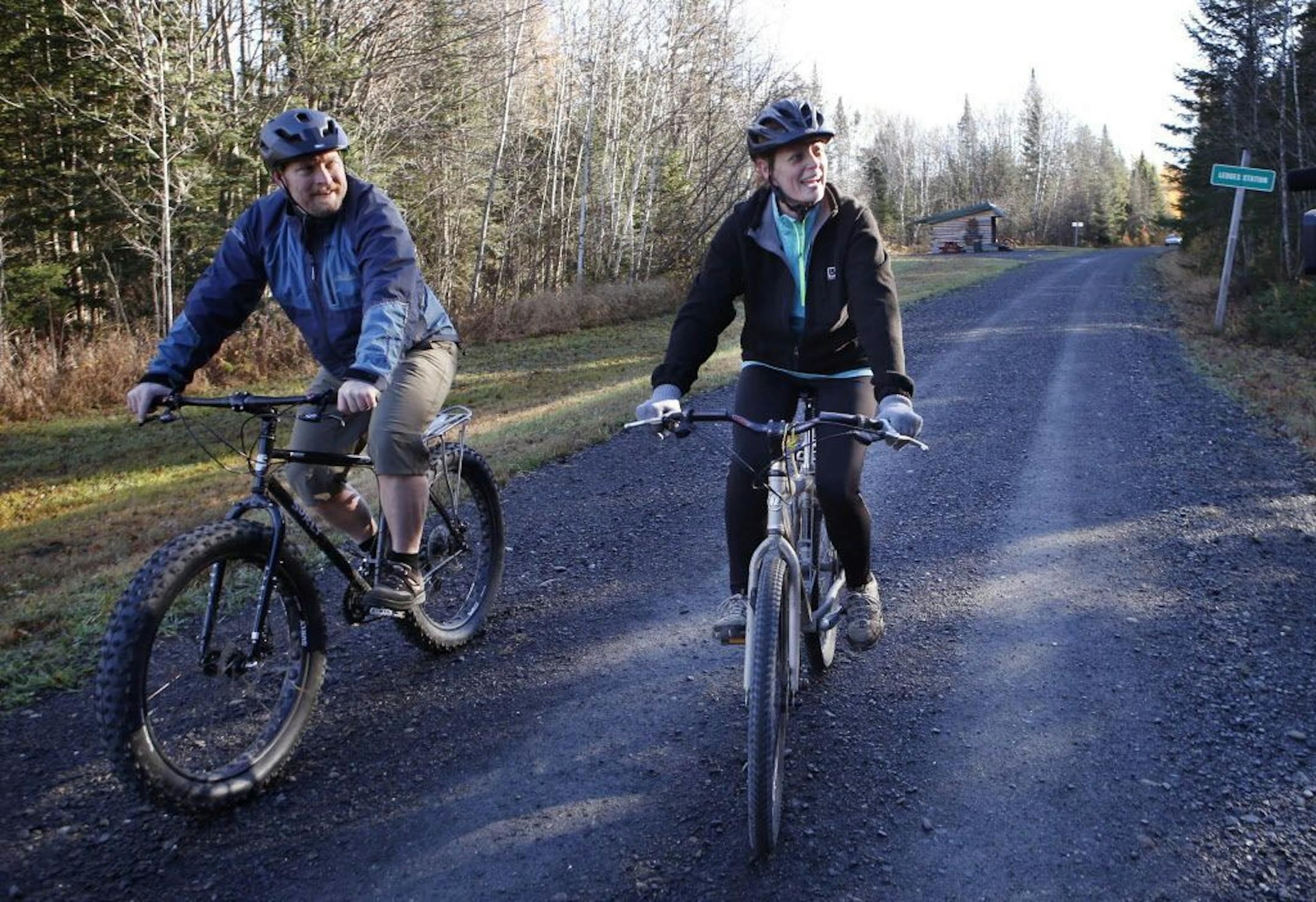 Nurse Kaci Hickox, right, and her boyfriend, Ted Wilbur, ride bikes on a trail near her home in Fort Kent, Maine, Thursday, Oct. 30, 2014.