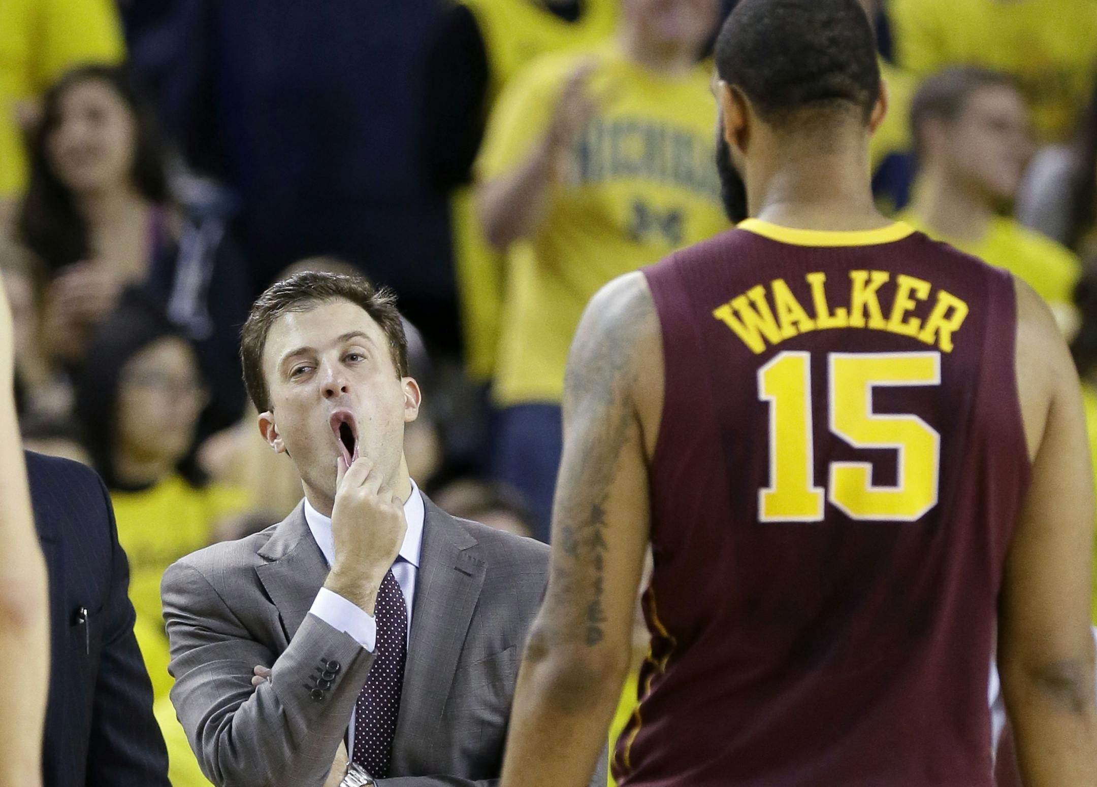 Minnesota head coach Richard Pitino reacts as Minnesota forward Maurice Walker (15) walks back to the bench during a timeout in the second half of an NCAA basketball game against Michigan, Saturday, Jan. 10, 2015, in Ann Arbor, Mich. Michigan defeated Minnesota 62-57.