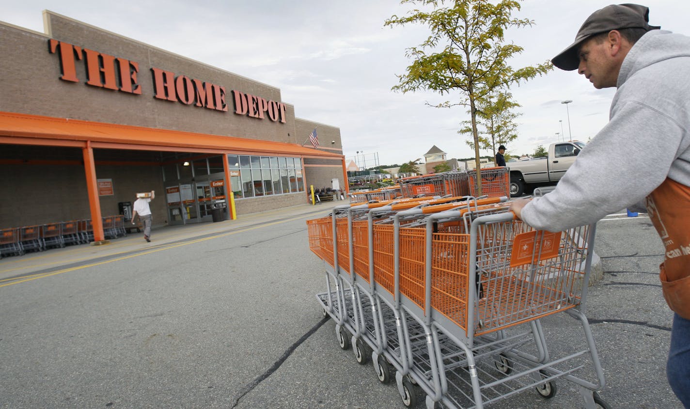 FILE - In this file photo made Oct. 6, 2009, employee John Abou Nasr pushes shopping carts in the parking lot of a Home Depot in Methuen, Mass. Home Depot&#x2019;s data breach could wind up being among the largest ever for a retailer, but that may not matter to its millions of customers. (AP Photo/Elise Amendola, File)