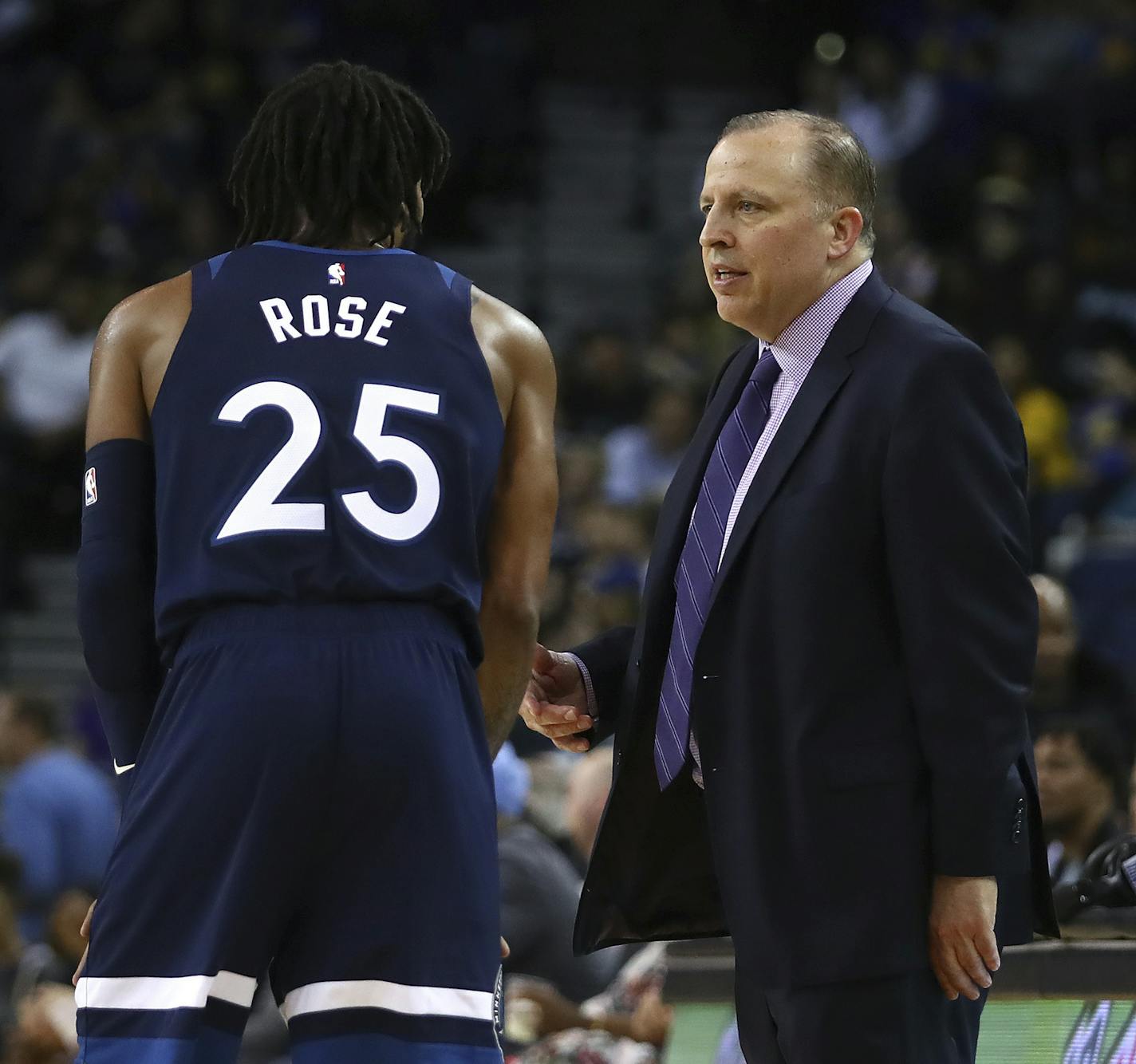 Minnesota Timberwolves' Derrick Rose (25) speaks with coach Tom Thibodeau during the second half of an NBA preseason basketball game against the Golden State Warriors, Saturday, Sept. 29, 2018, in Oakland, Calif. (AP Photo/Ben Margot)