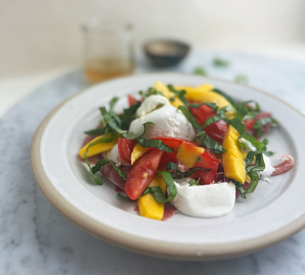 Burrata, Mango and Tomato Salad is a quick summer meal that beats the heat. 