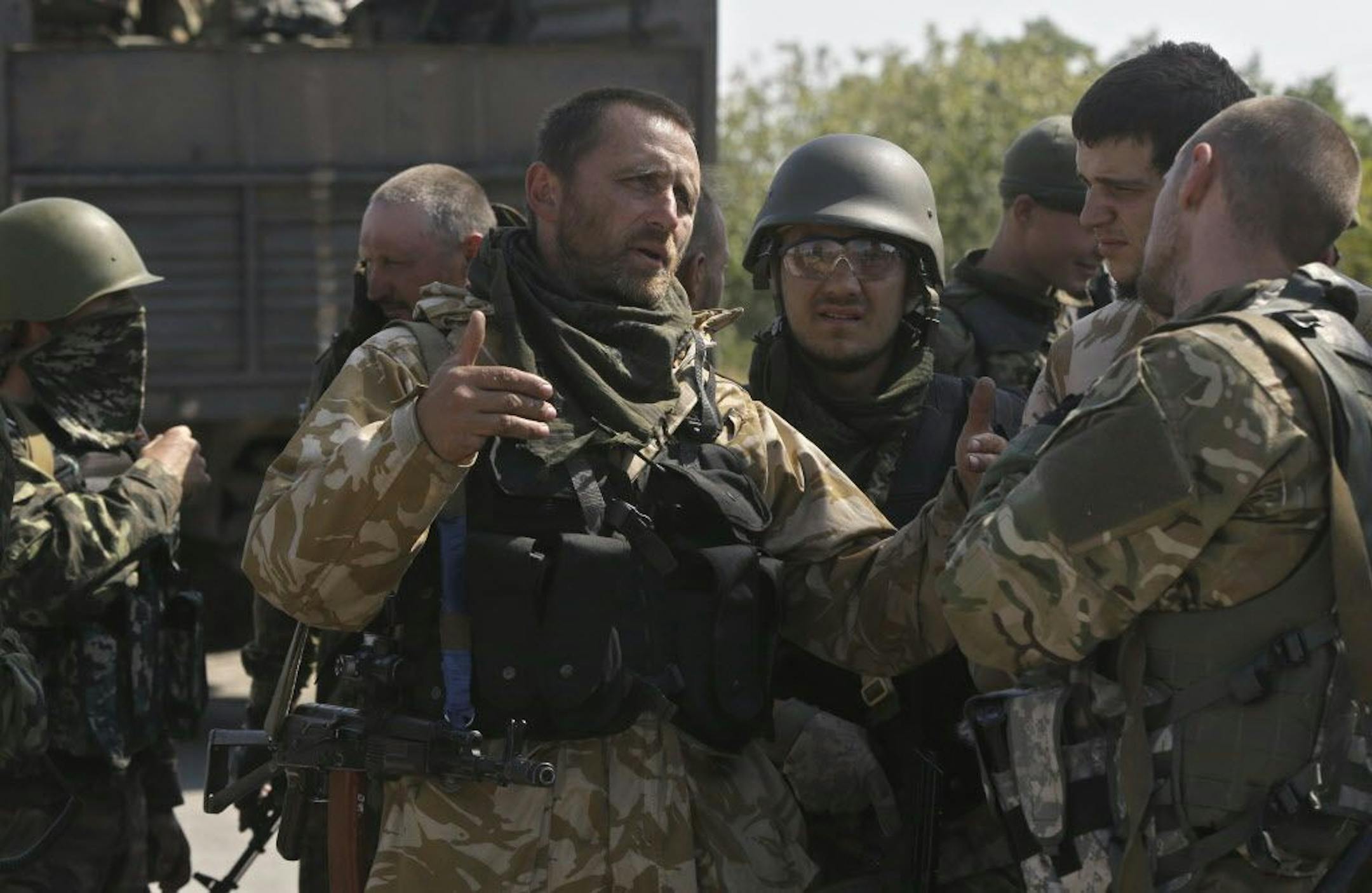 Ukrainian soldiers of special battalion "Azov" talk at a checkpoint in the port city of Mariupol, southeastern Ukraine, Friday, Sept. 5, 2014.