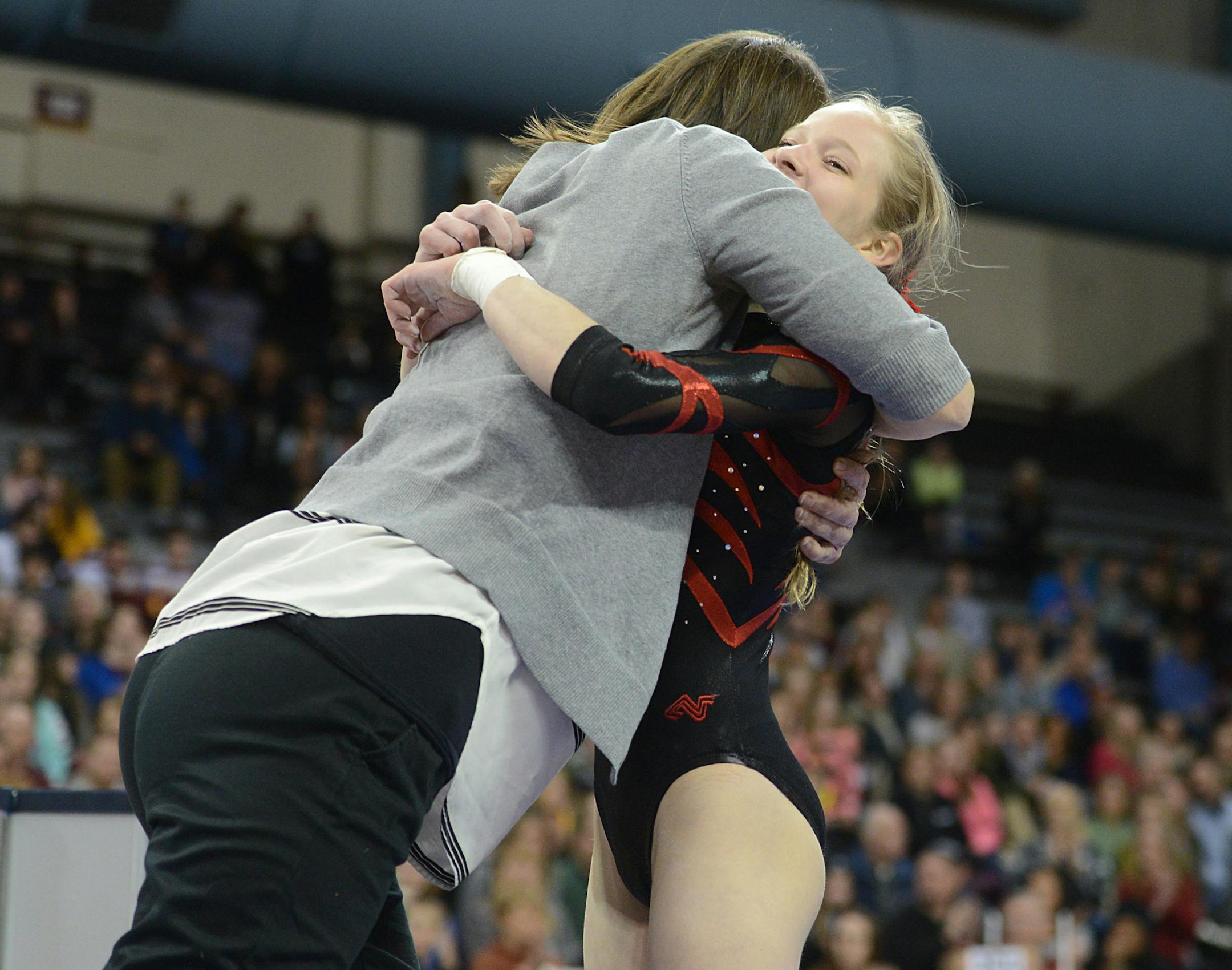 Eight grade Stillwater gymnast Gretchen Sharp hugs one of her coaches after performance on balance beam.] BRIDGET BENNETT &#x2022; Special to the Star Tribune bridget.bennett@startribune.com Class 2A Individual and All-Around Championships of the 2015 State Girls Gymnastics Meet at the University of Minnesota Sports Pavilion on Saturday, Feb. 21, 2015.