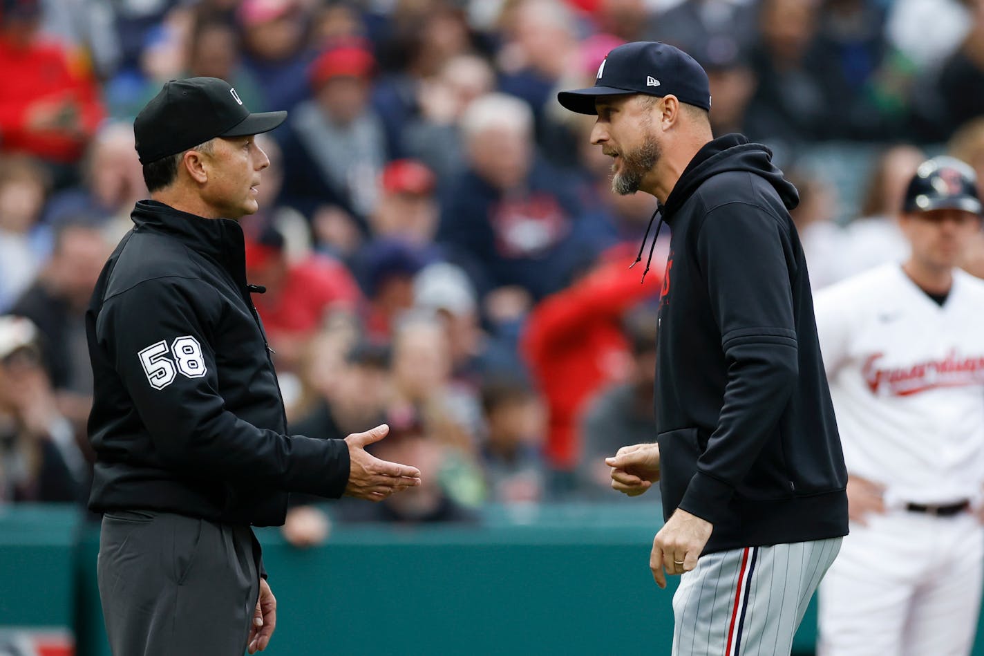 Minnesota Twins manager Rocco Baldelli, right, argues a call with umpire Dan Iassogna (58) after being ejected from the game during the fourth inning of a baseball game against the Cleveland Guardians, Saturday, May 6, 2023, in Cleveland. (AP Photo/Ron Schwane)